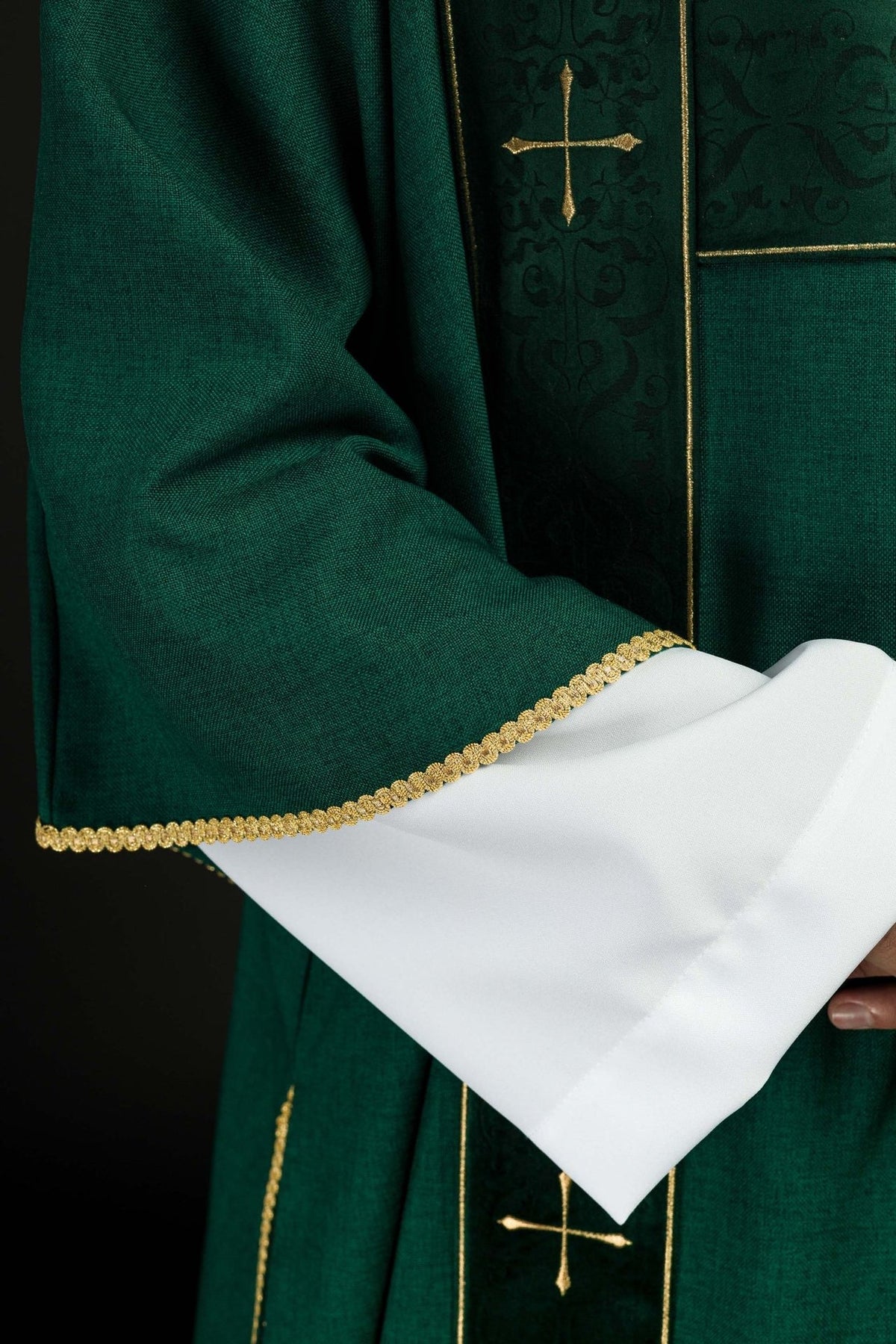 Green dalmatic sleeve with gold trim and white cuff