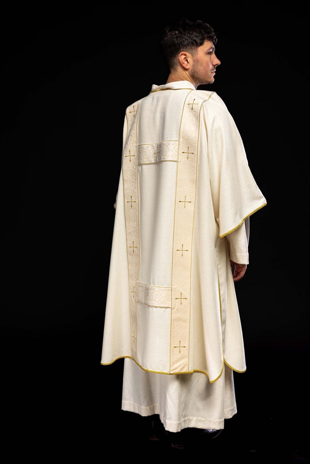 Ecru dalmatic rear three-quarter view with velvet orphreys and gold trim