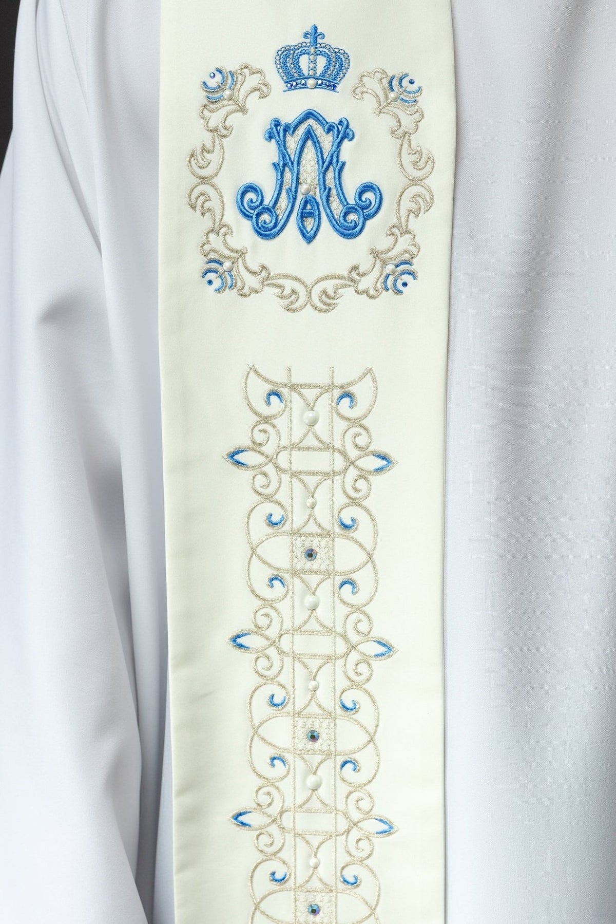 Marian stole close-up showing blue crowned Marian symbol with pearl details
