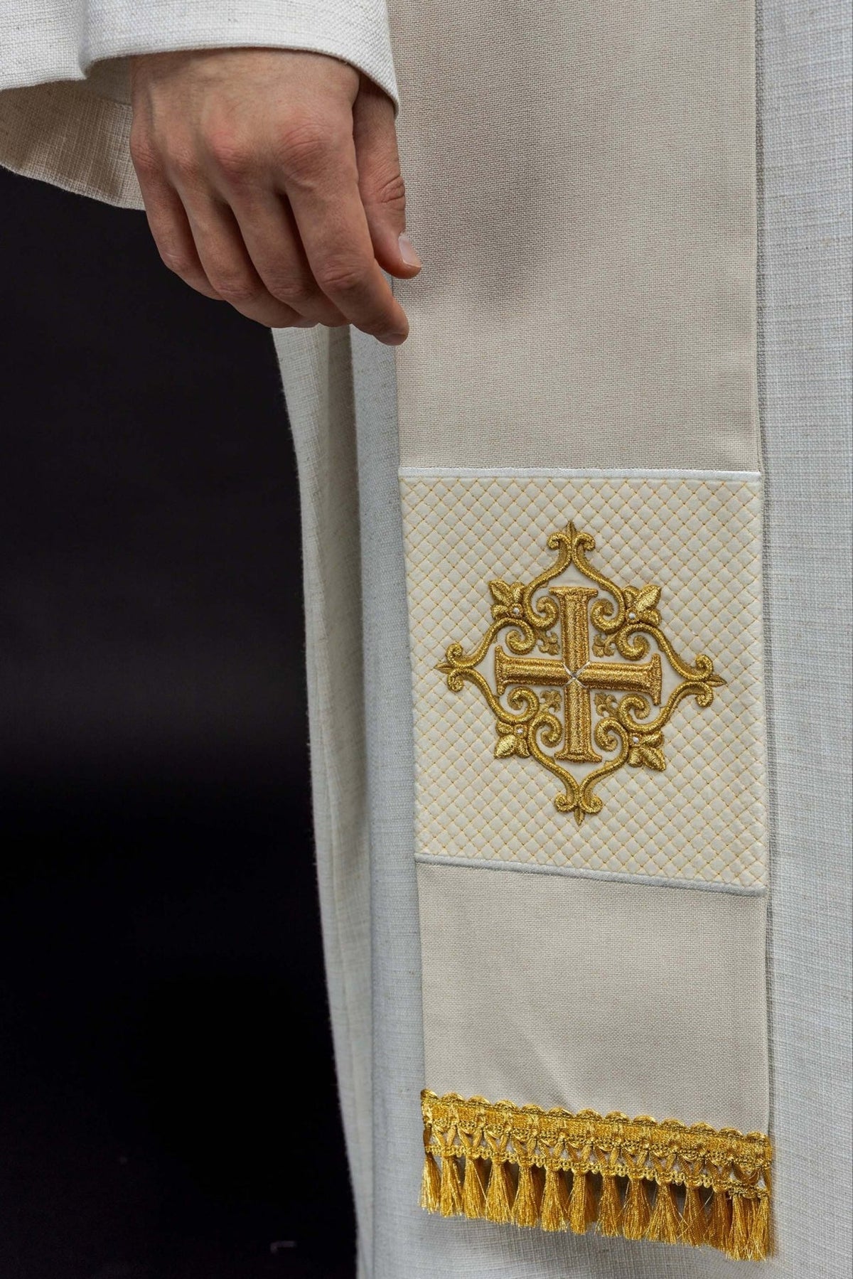 Ecru velvet stole close-up showing embroidered gold cross and diamond pattern