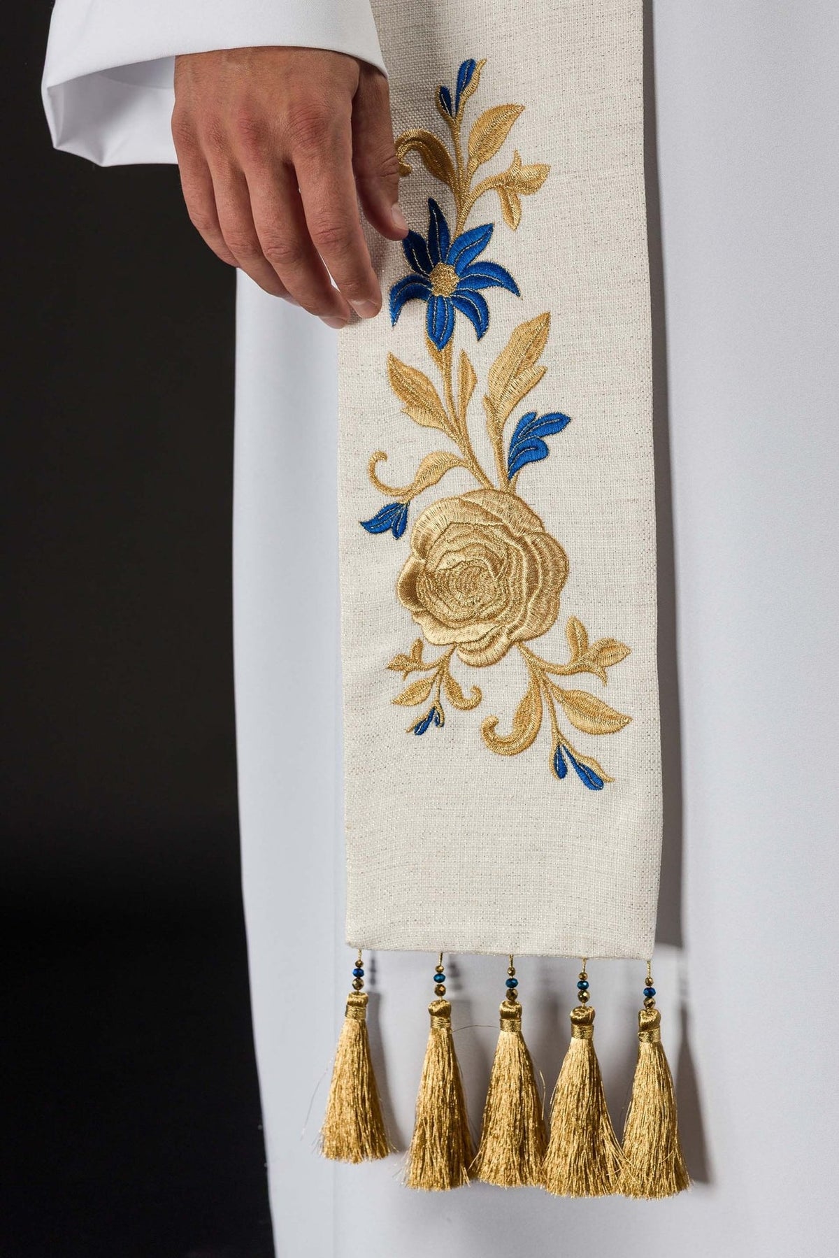 Embroidered stole detail with gold rose and blue flower embroidery