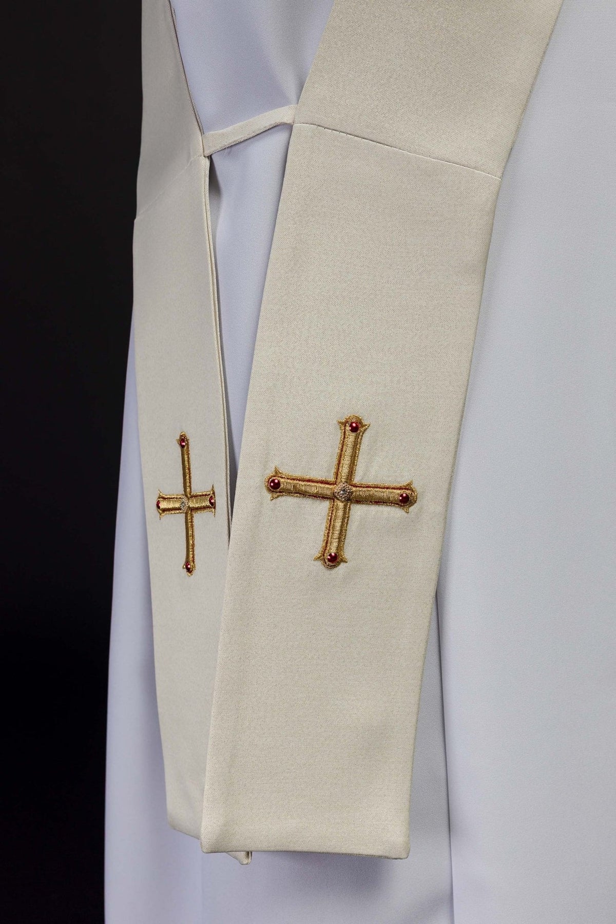 Deacon stole detail showing gold cross embroidery with red accents on both ends