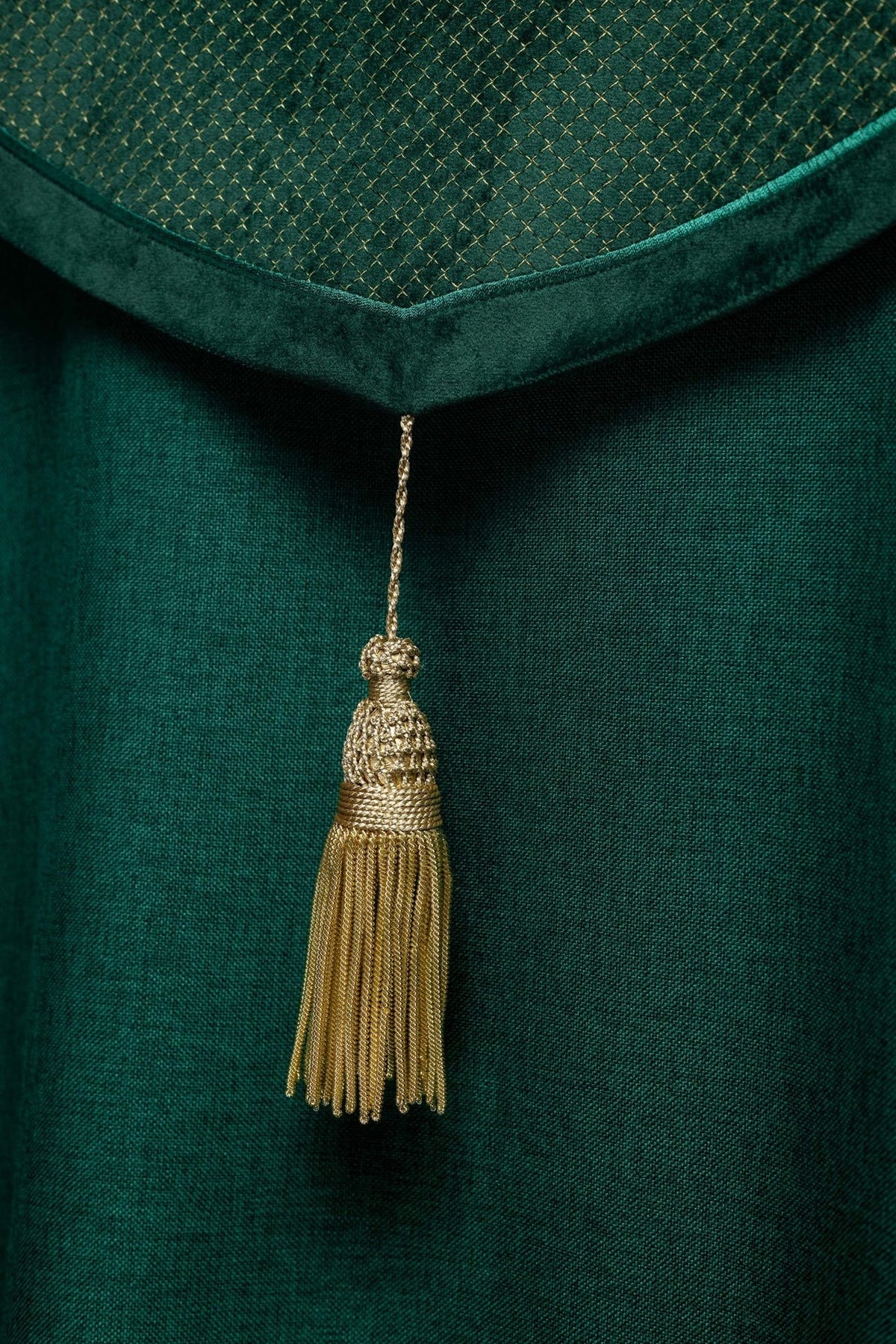 Green velvet cope, close-up of gold tassel beneath the orphrey