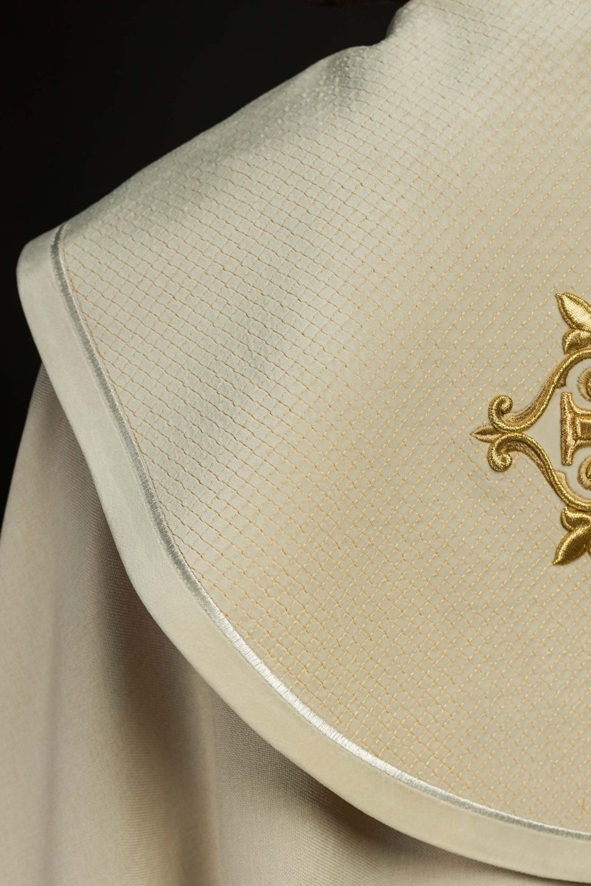 Ecru cope shoulder close-up showing velvet orphrey, gold grid embroidery and edging
