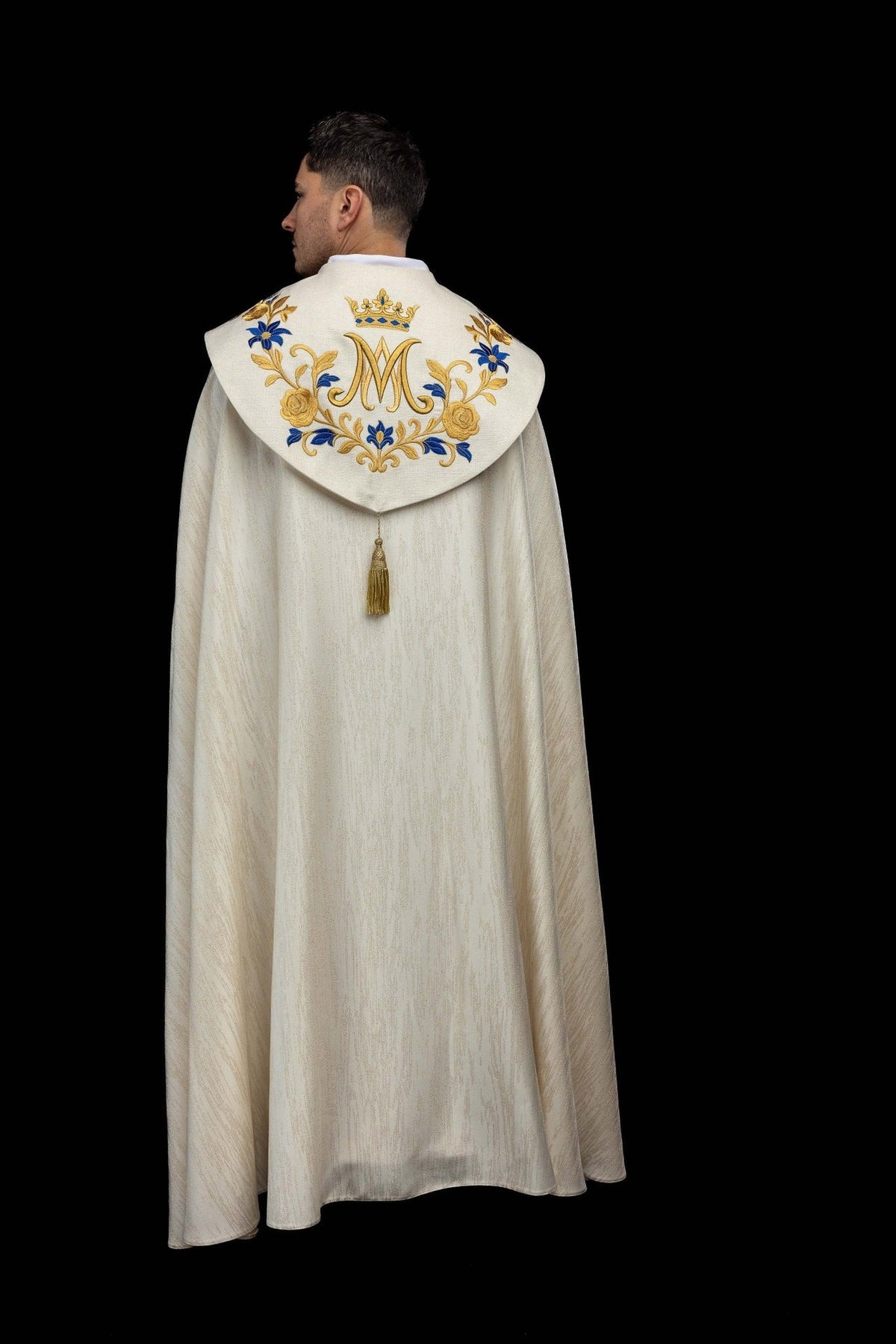 Ecru cope back view with embroidered Marian symbol, floral motifs and gold tassel