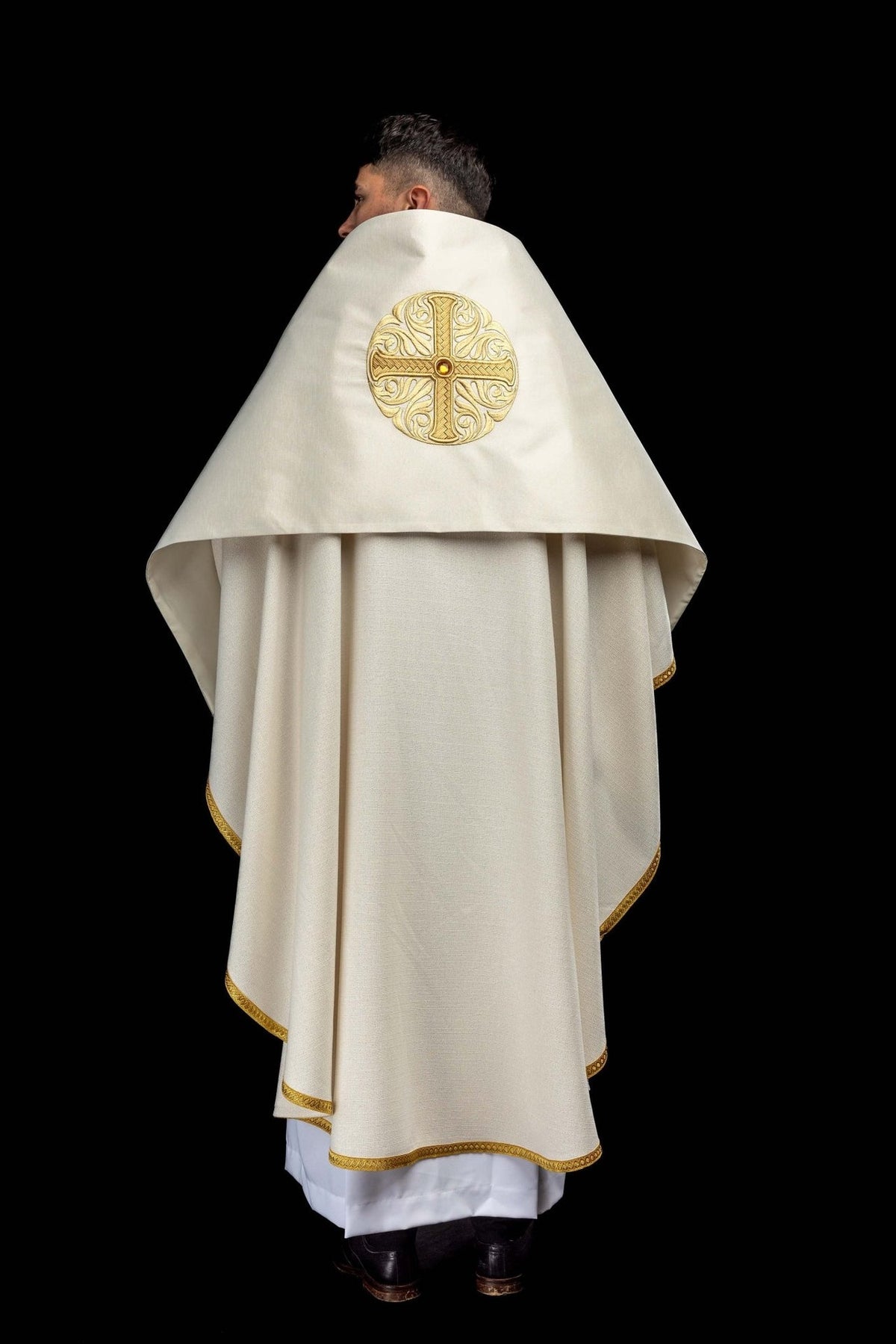 Humeral veil worn from the back with embroidered gold cross and decorative stone