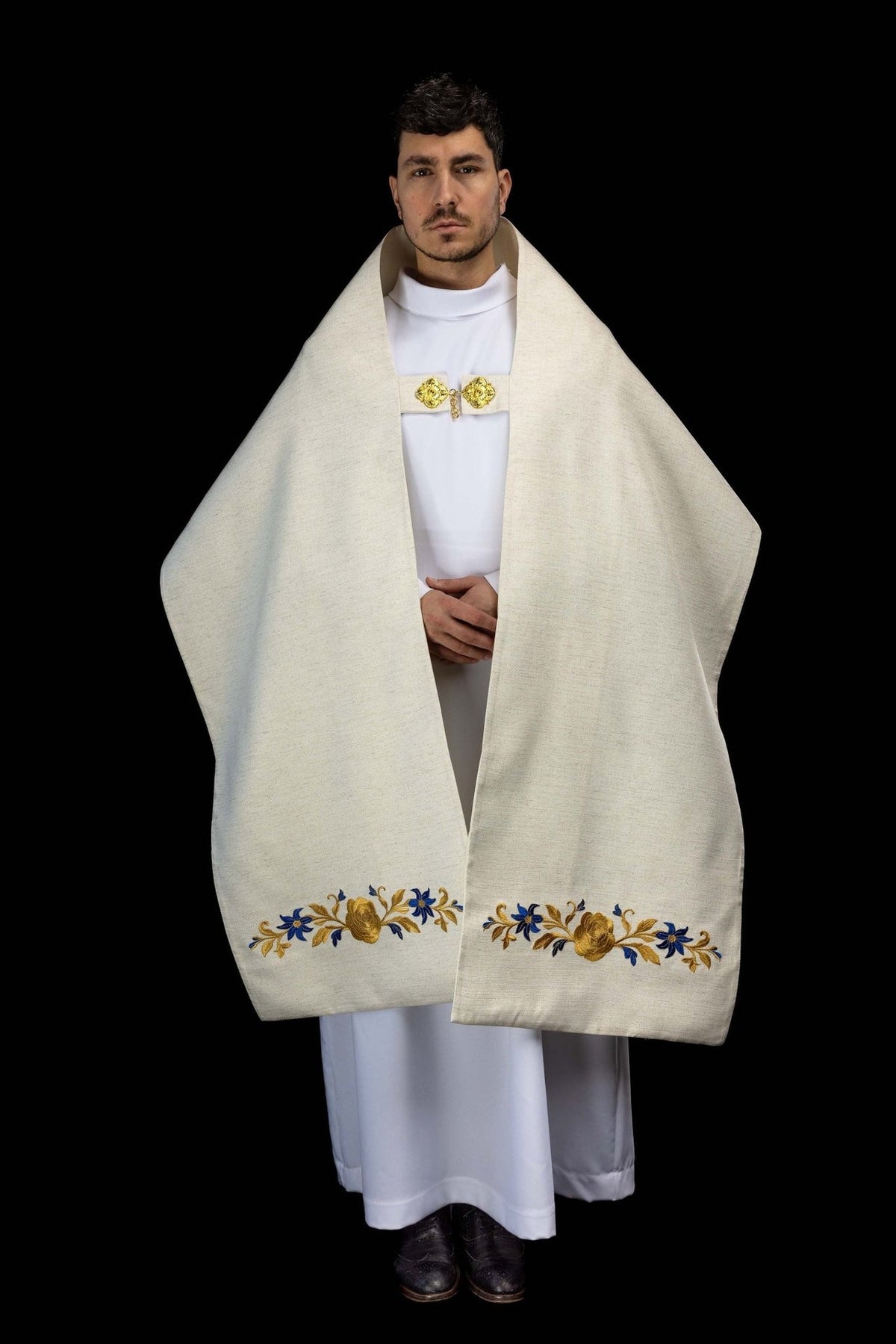 Ecru embroidered humeral veil worn front view with gold clasp and floral embroidery