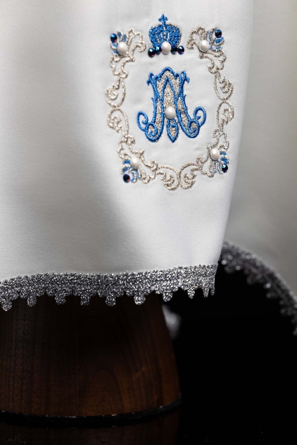 Chalice veil close-up showing blue Marian symbol, beaded embroidery and silver trim