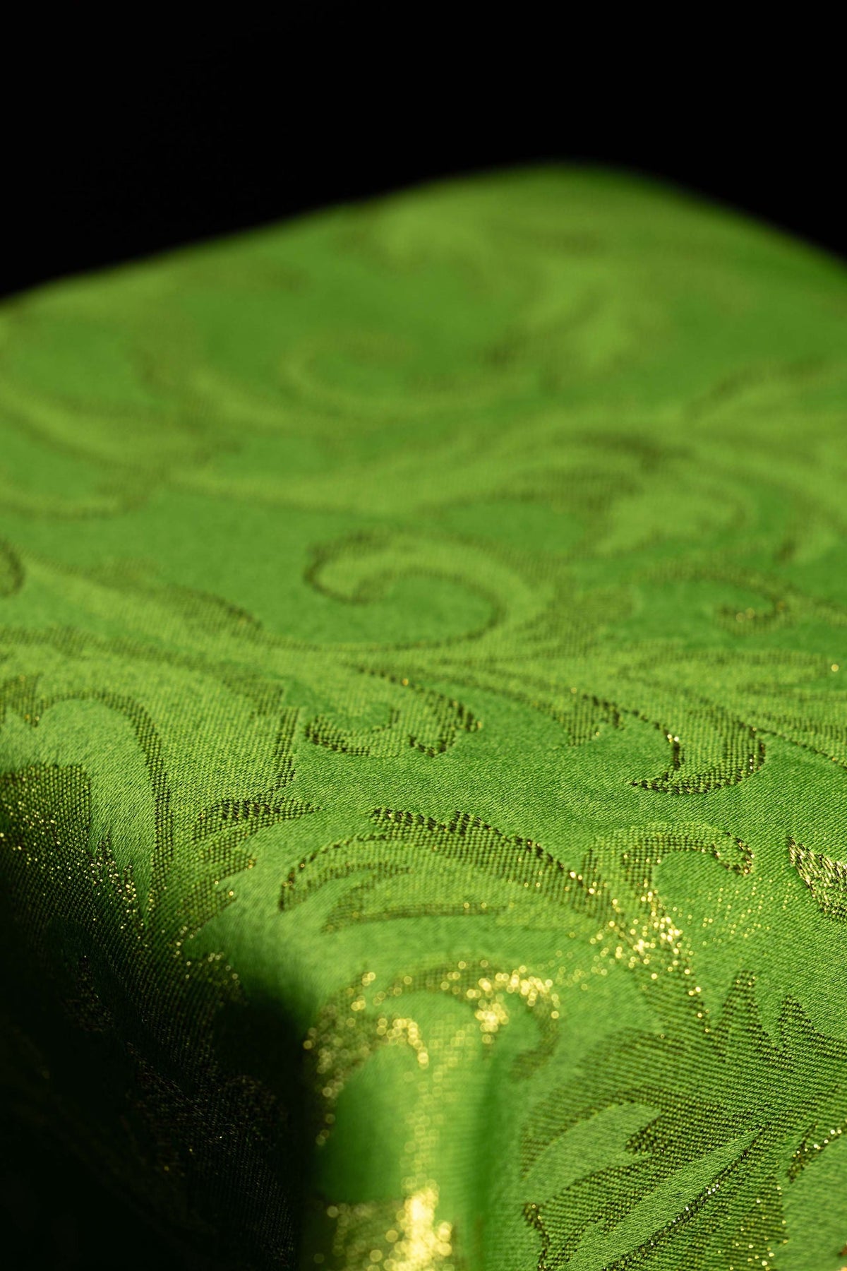 Green chalice veil close-up showing embroidered woven fabric pattern