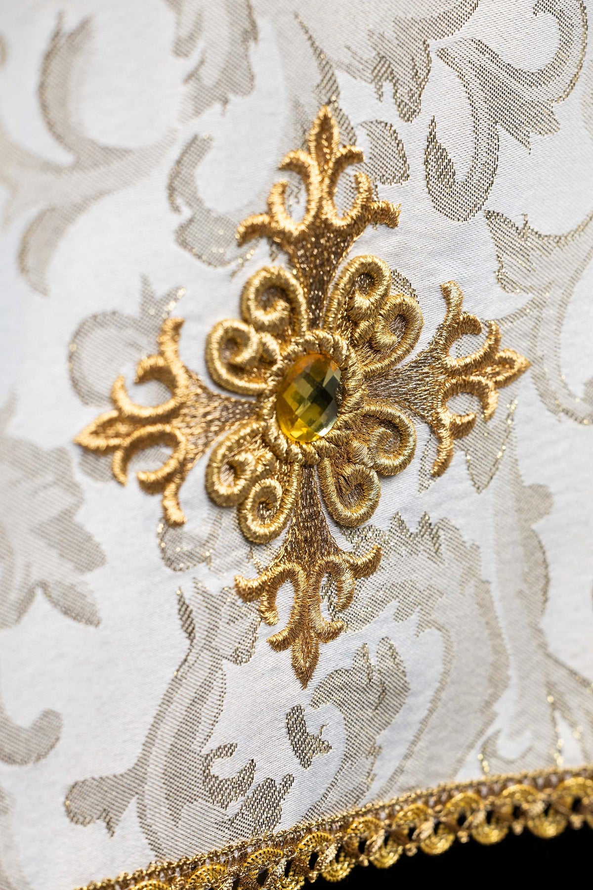 Chalice veil close-up of embroidered cross motif with ecru stone and gold trim