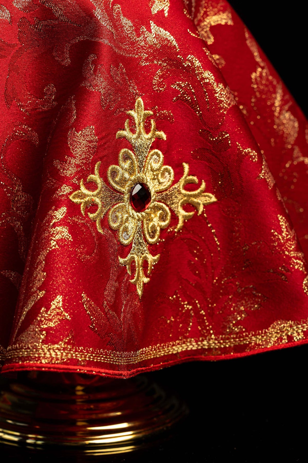 Ciborium veil close-up showing embroidered cross, central stone, and gold brocade