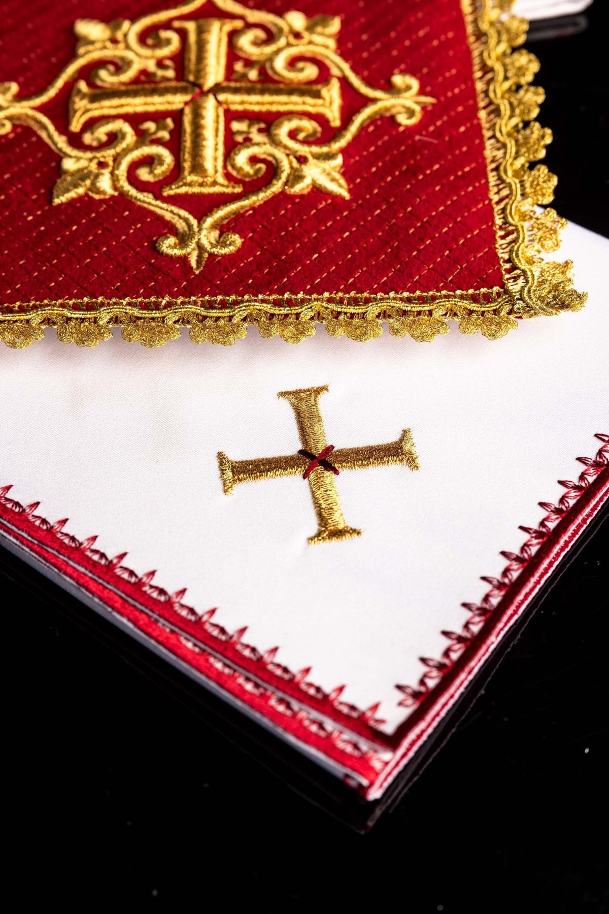 Chalice pall close-up showing red velvet fabric, gold embroidery and decorative gold fringe
