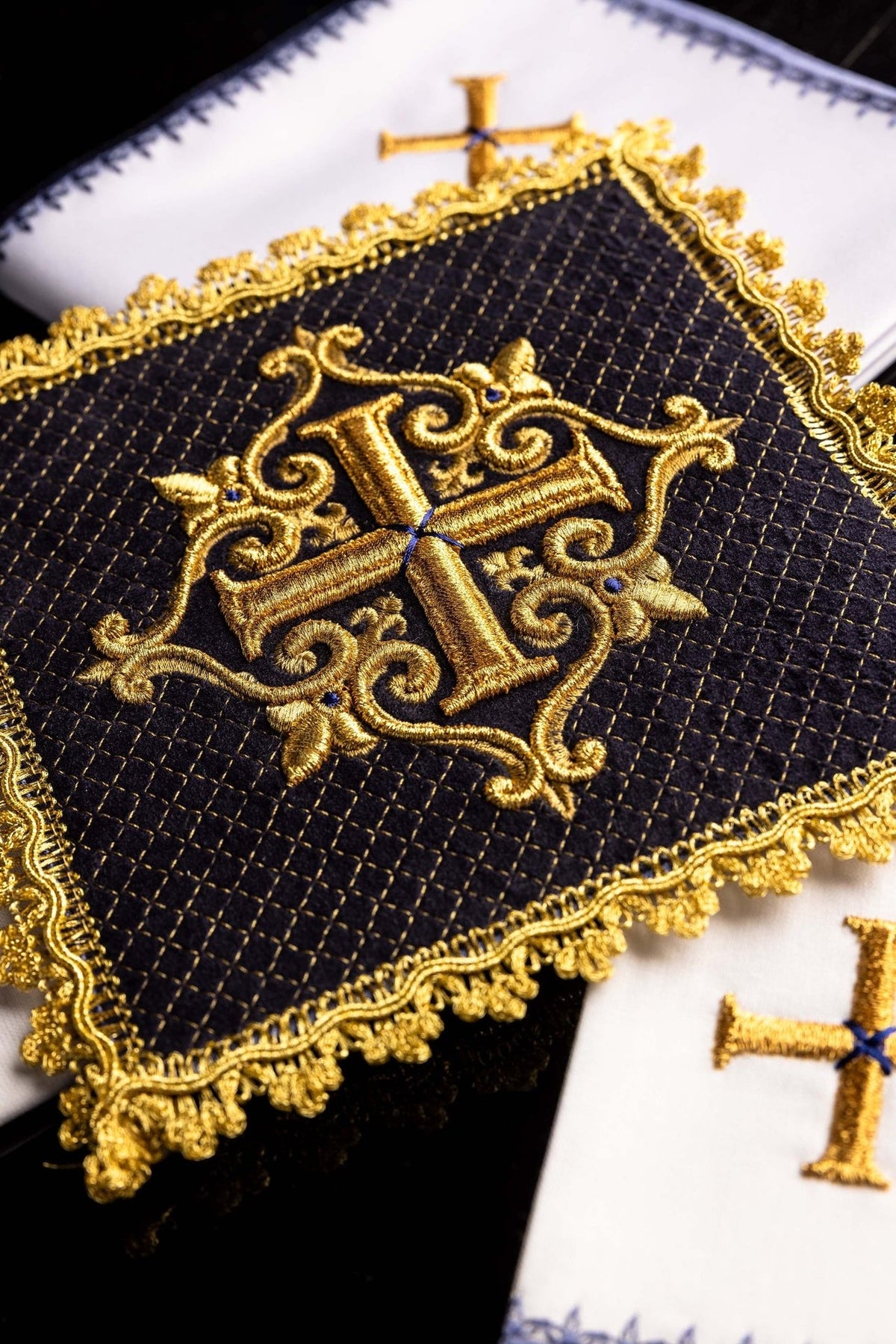 Purple velvet altar linen set close-up with ornate gold cross embroidery and decorative trim