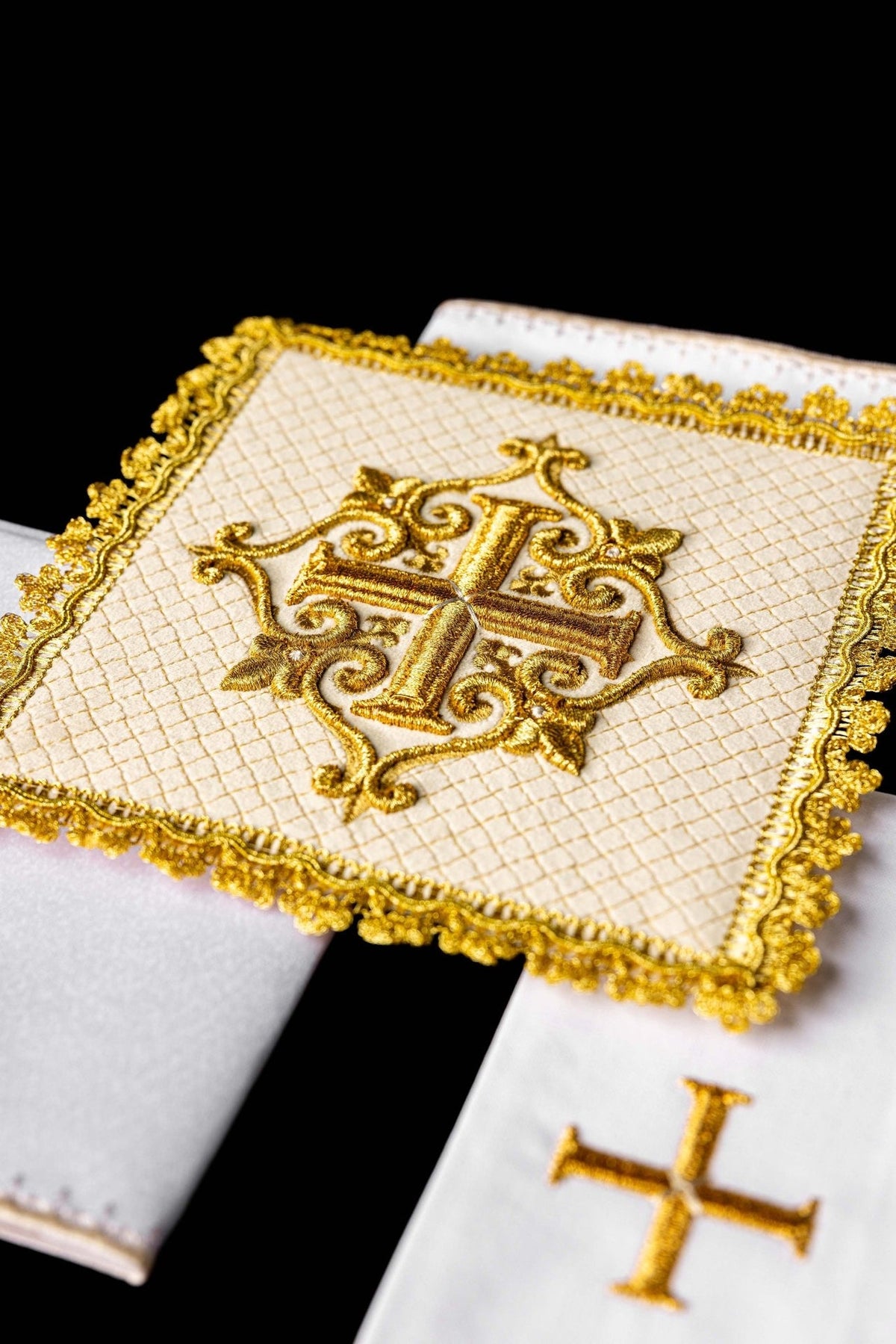 Embroidered altar linen set close-up showing ornate gold cross and decorative edging
