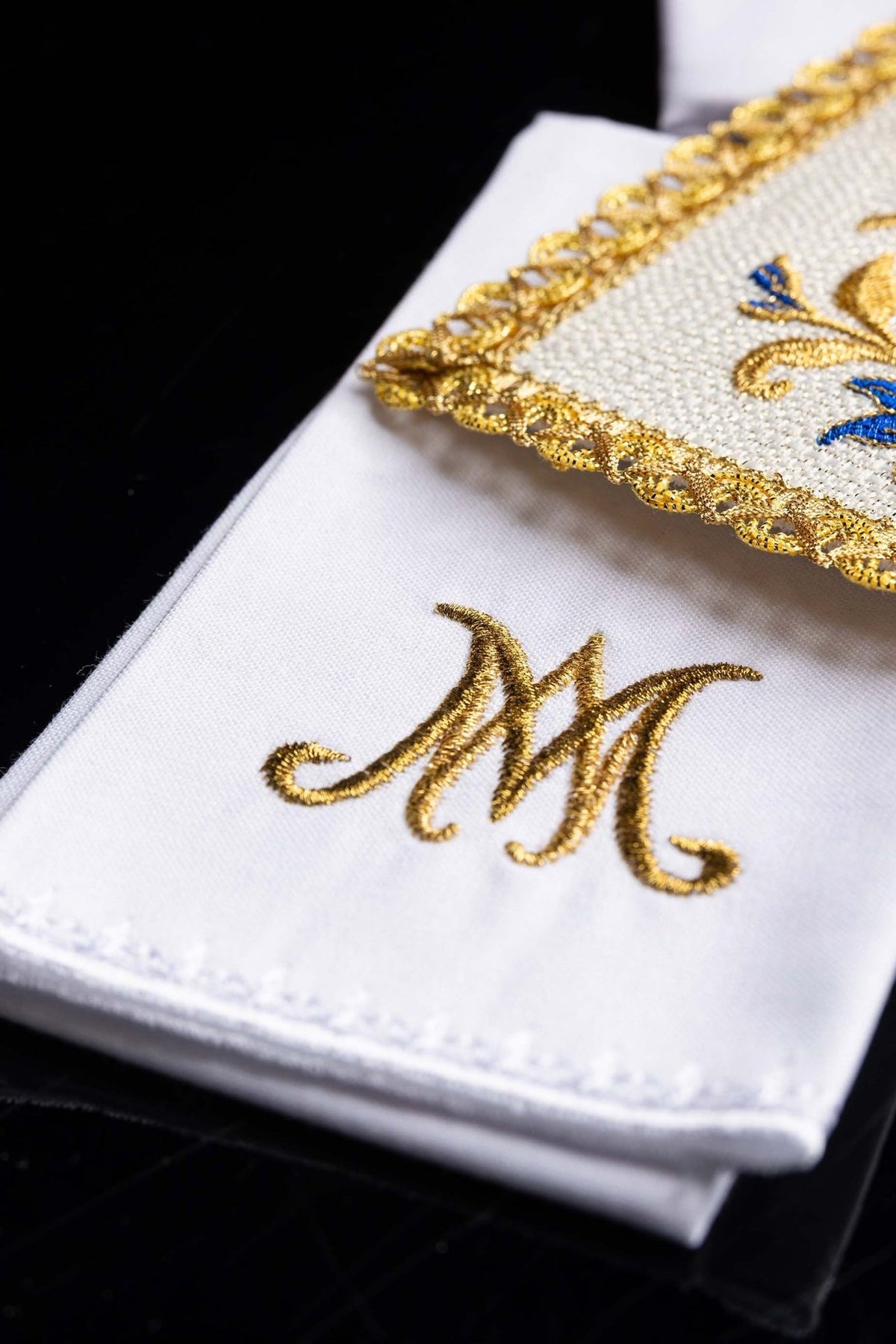 Altar linen set detail with gold and blue floral embroidery and scalloped trim