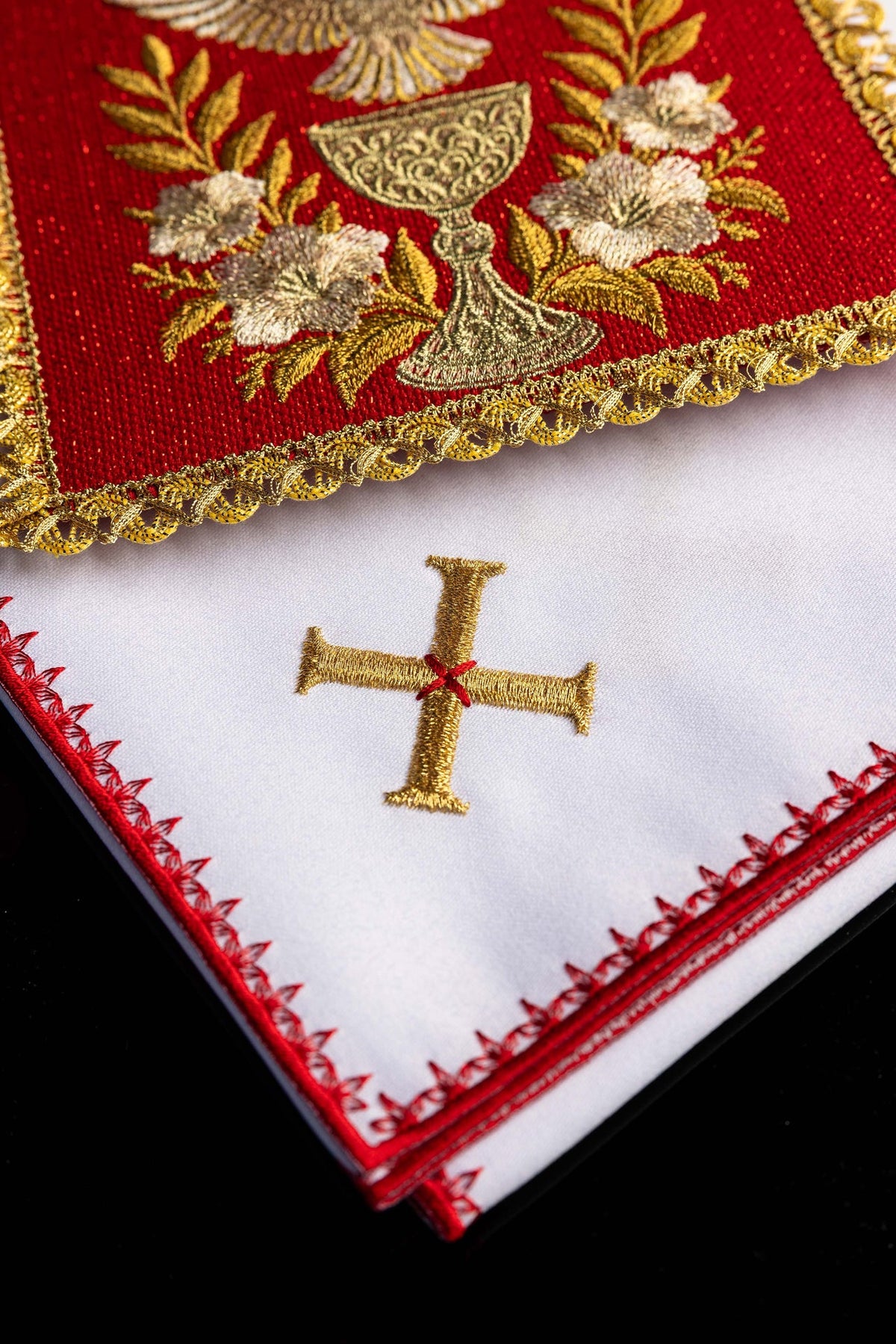 Altar linen set close-up showing gold embroidered cross and red edging