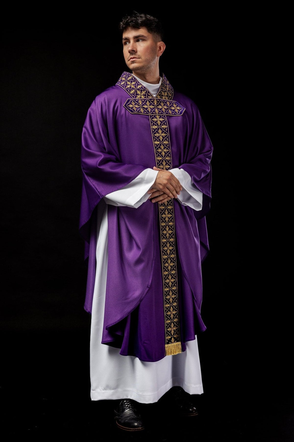 Purple chasuble worn in front three-quarter view with embroidered cross orphrey