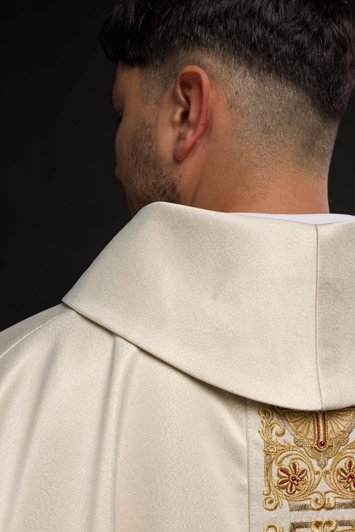 Chasuble embroidered orphrey close-up with gold crosses, floral motifs and red accents
