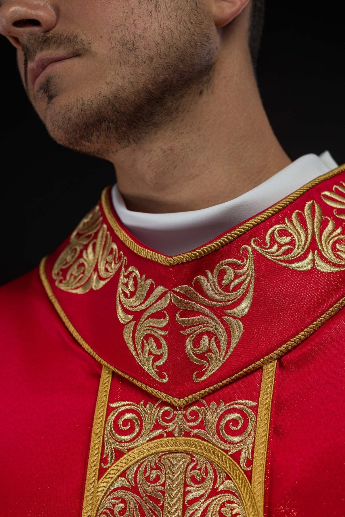 Red chasuble close-up of embroidered orphrey with faceted stone