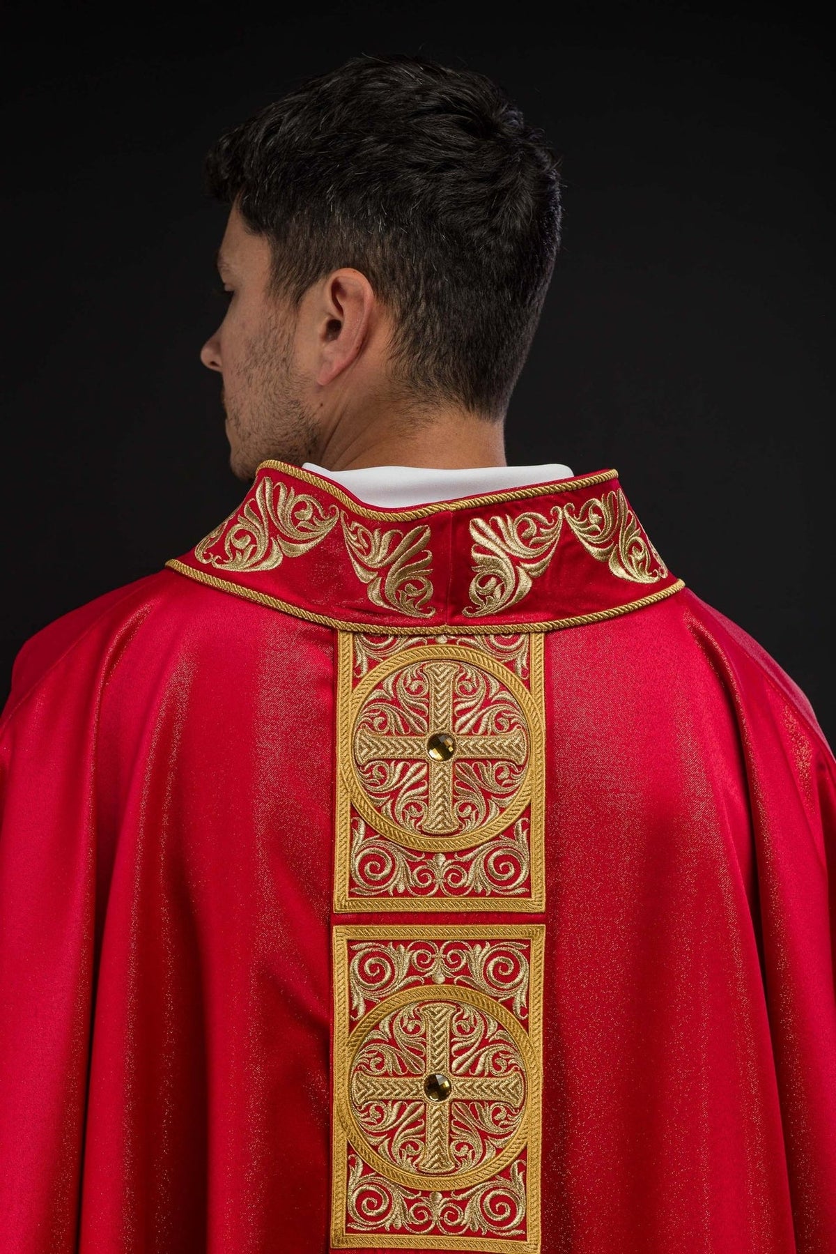 Red chasuble stand-up collar close-up with gold embroidered scrollwork