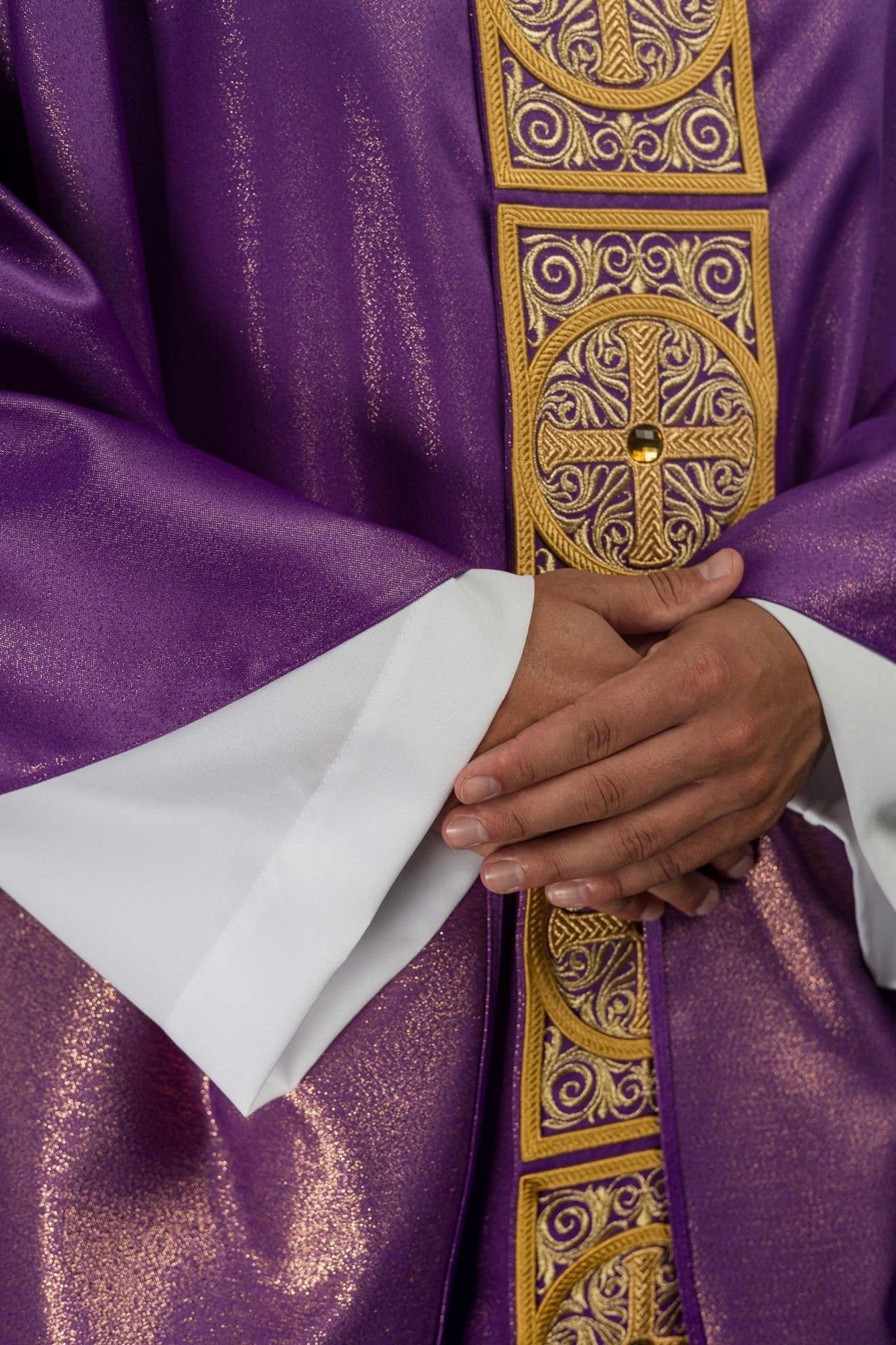 Purple chasuble close-up of embroidered orphrey with cross motifs and faceted stones