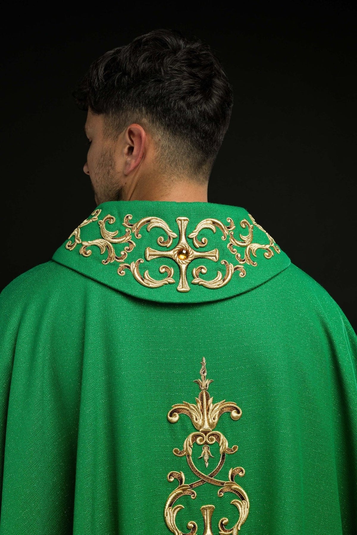 Green chasuble back view with gold embroidered collar and vertical motif
