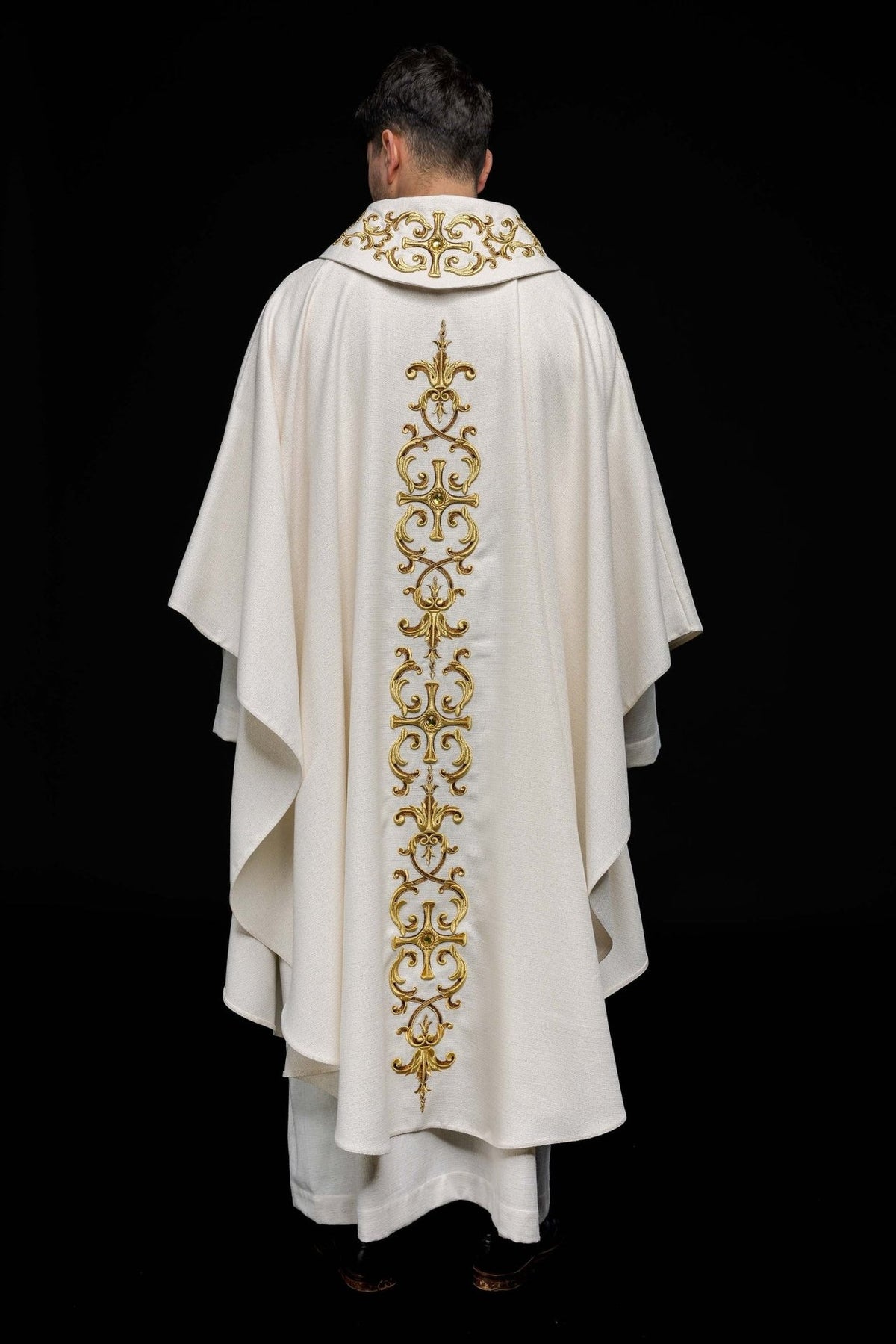 Catholic chasuble, full white back view with a long gold embroidered motif