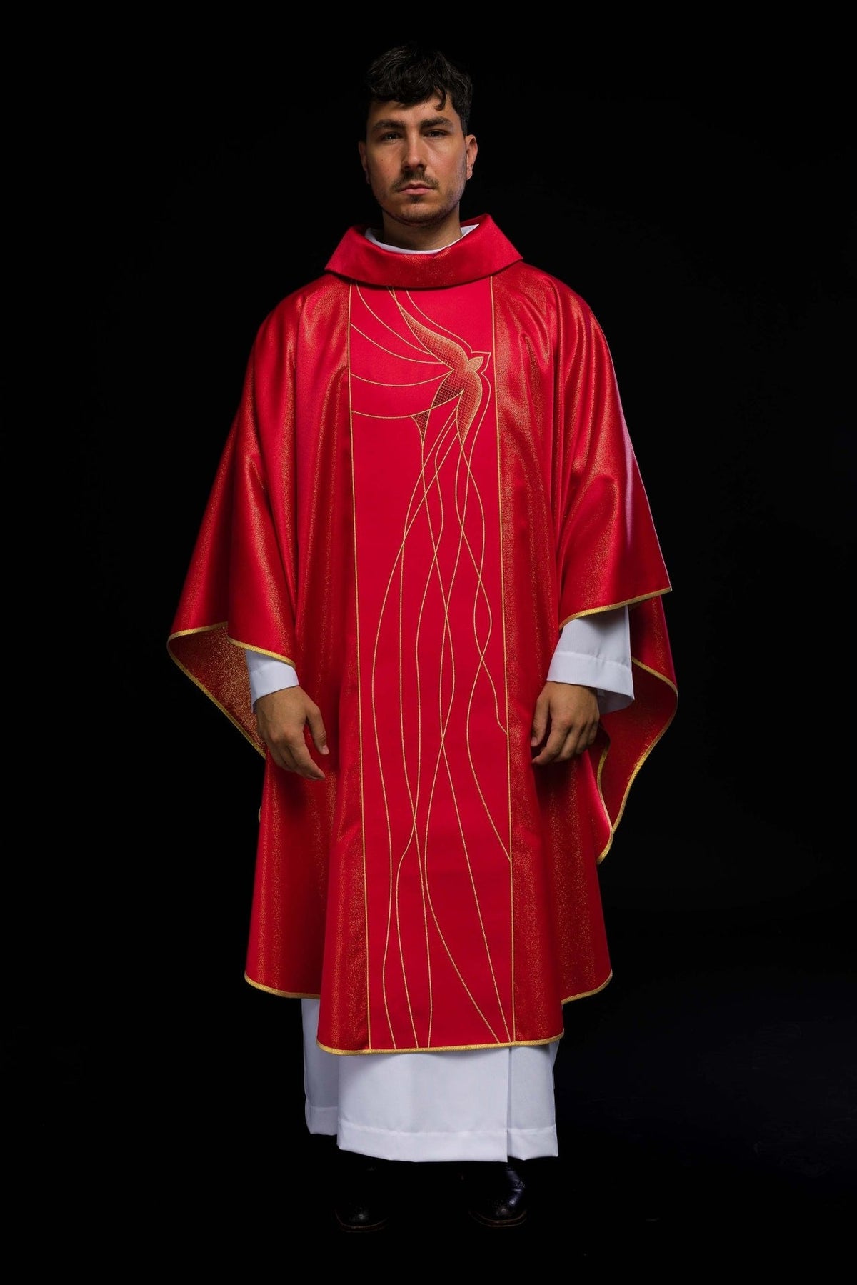 Red chasuble front view showing Holy Spirit embroidery and gold-trimmed edges