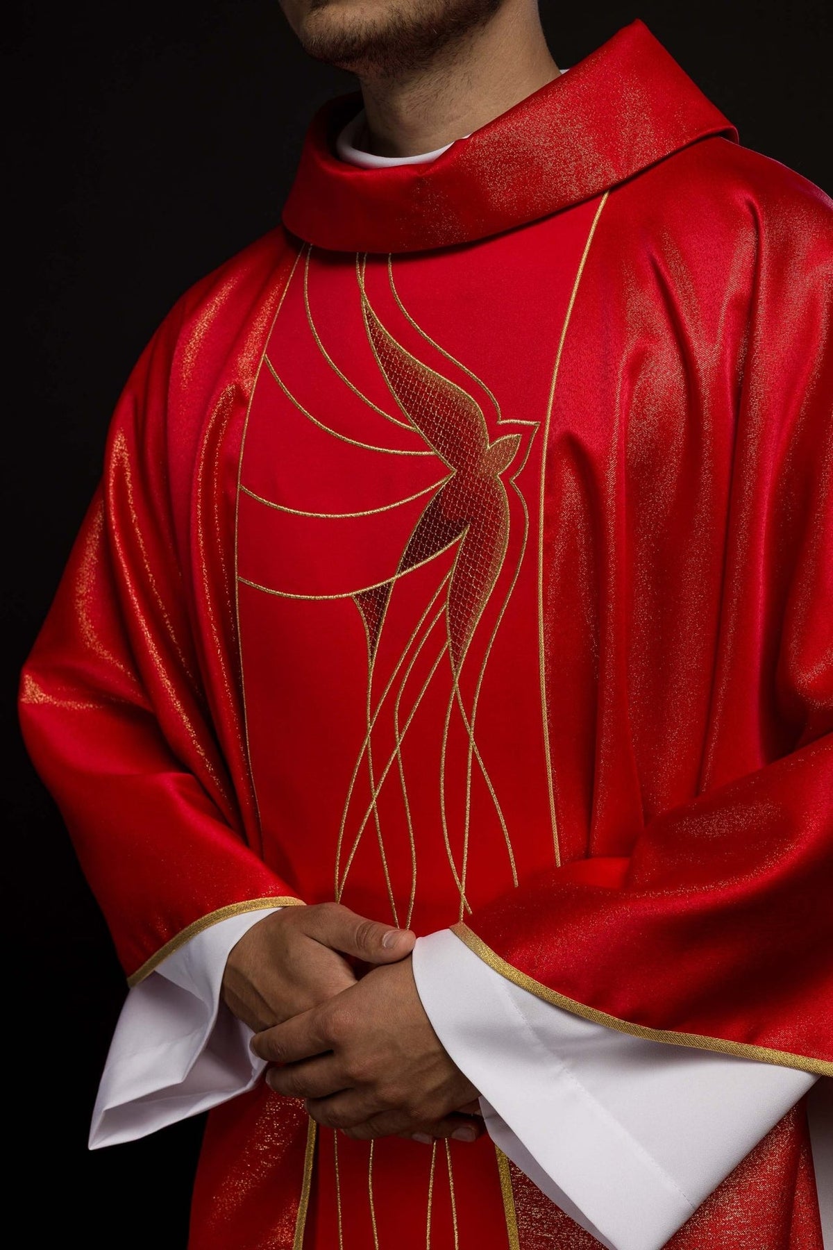 Red chasuble close-up showing stand-up collar and Holy Spirit embroidery