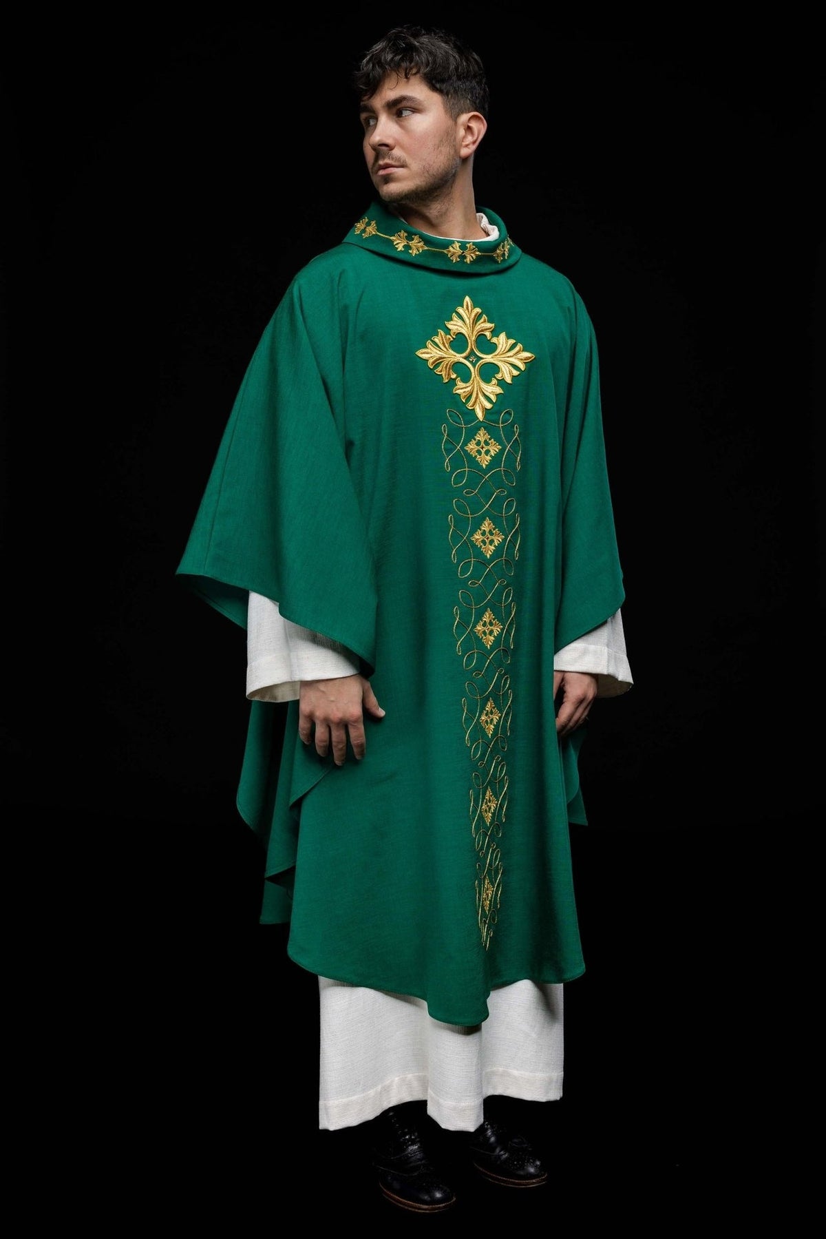 Green chasuble, full front view with embroidered gold cross and vertical cord motifs