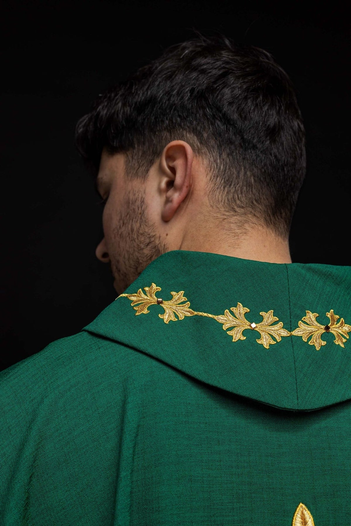 Green chasuble, front detail showing embroidered cross, cords and stones