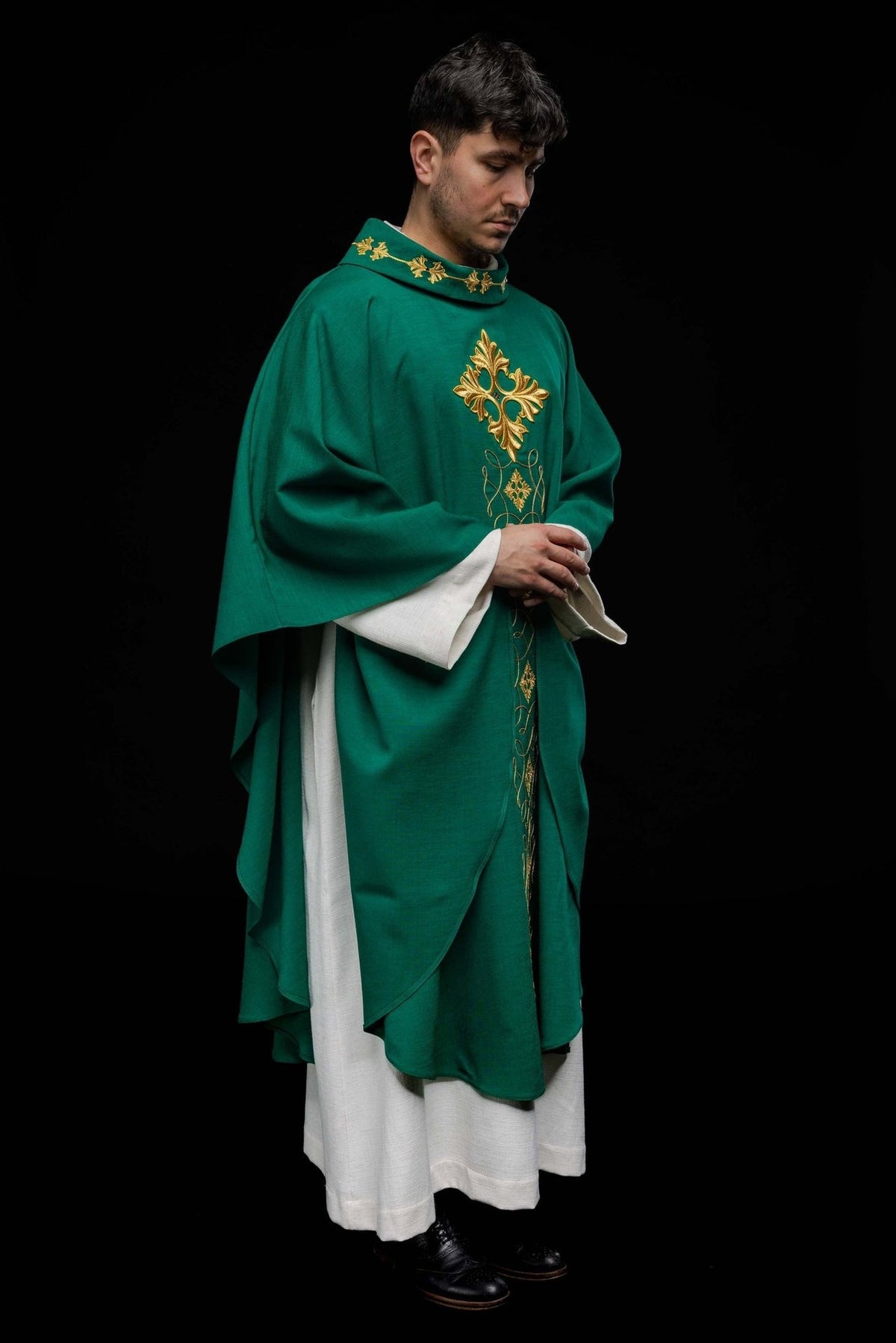 Green chasuble, side view showing flowing shape and embroidered front motifs
