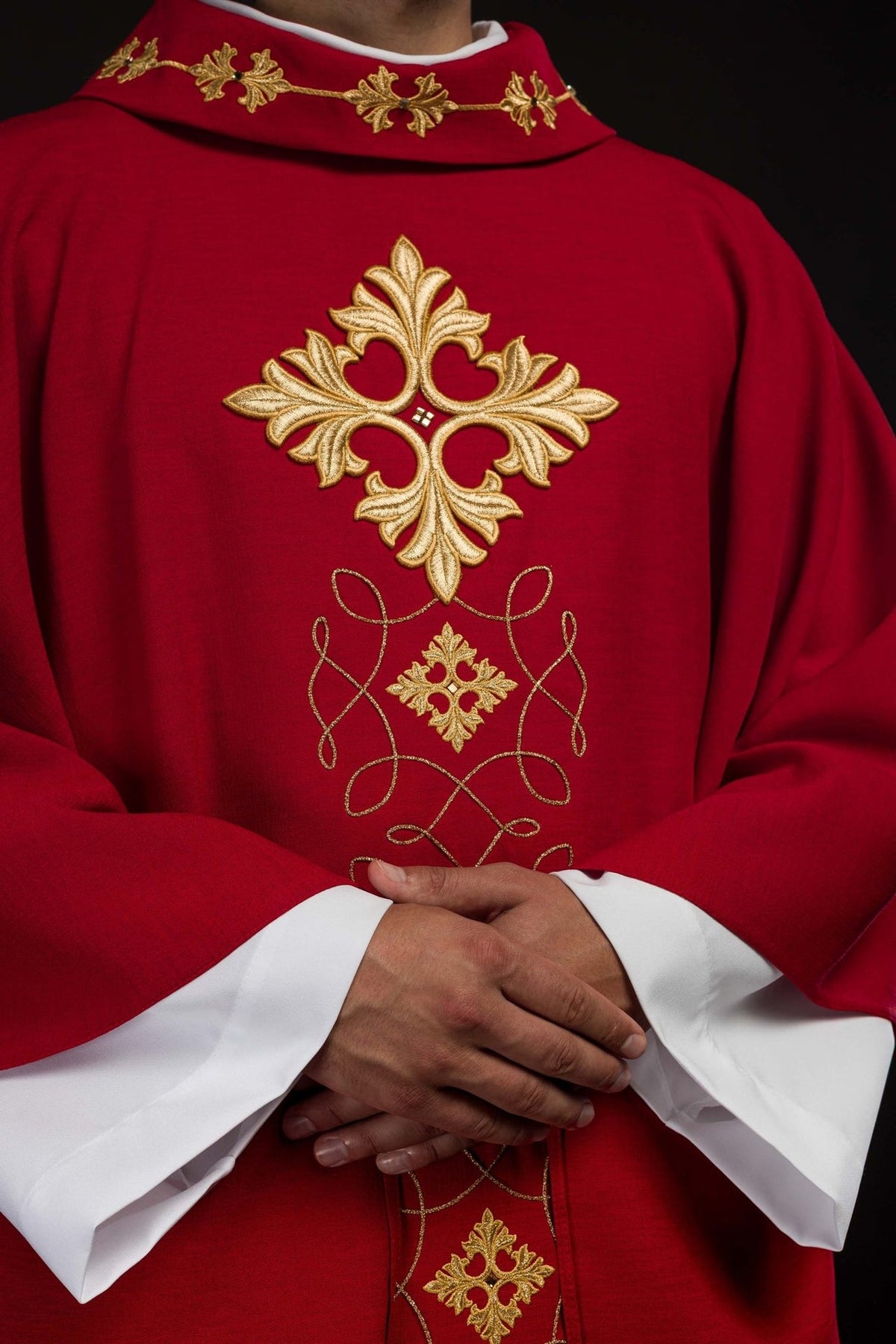 Red chasuble, front detail showing gold embroidered cross, stones and collar decoration