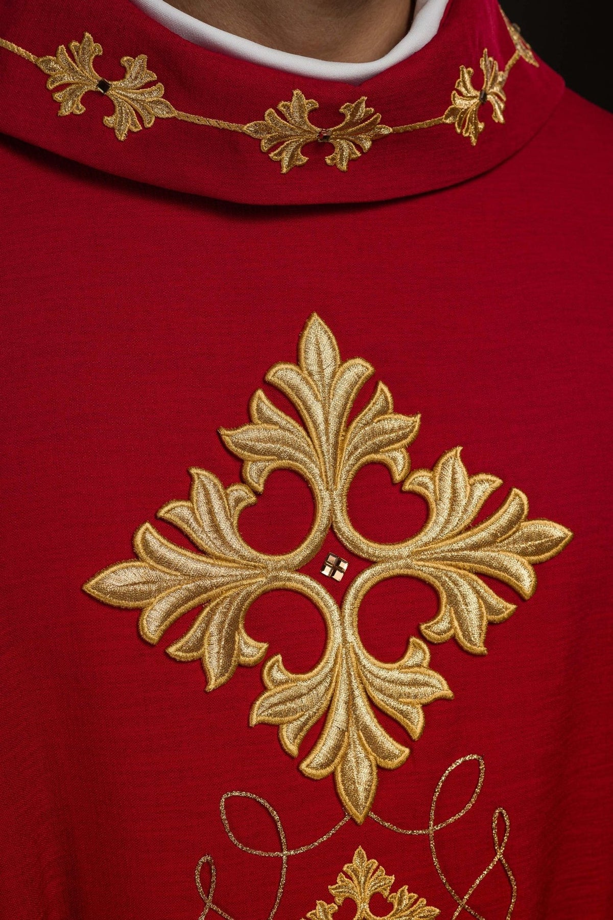 Red chasuble, close-up of stand-up collar and large gold embroidered cross