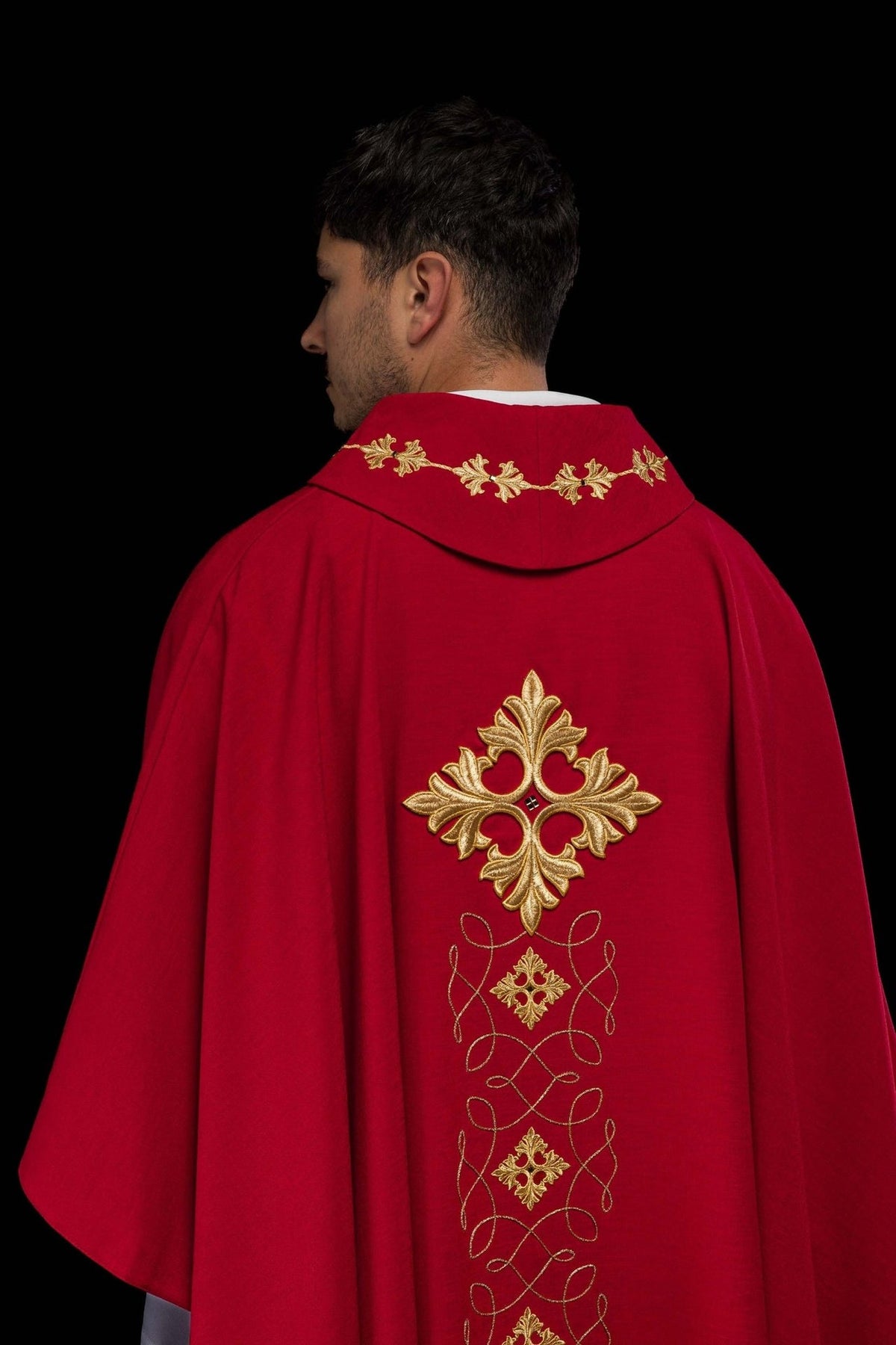 Red chasuble, back view with gold embroidered cross and vertical cord motifs