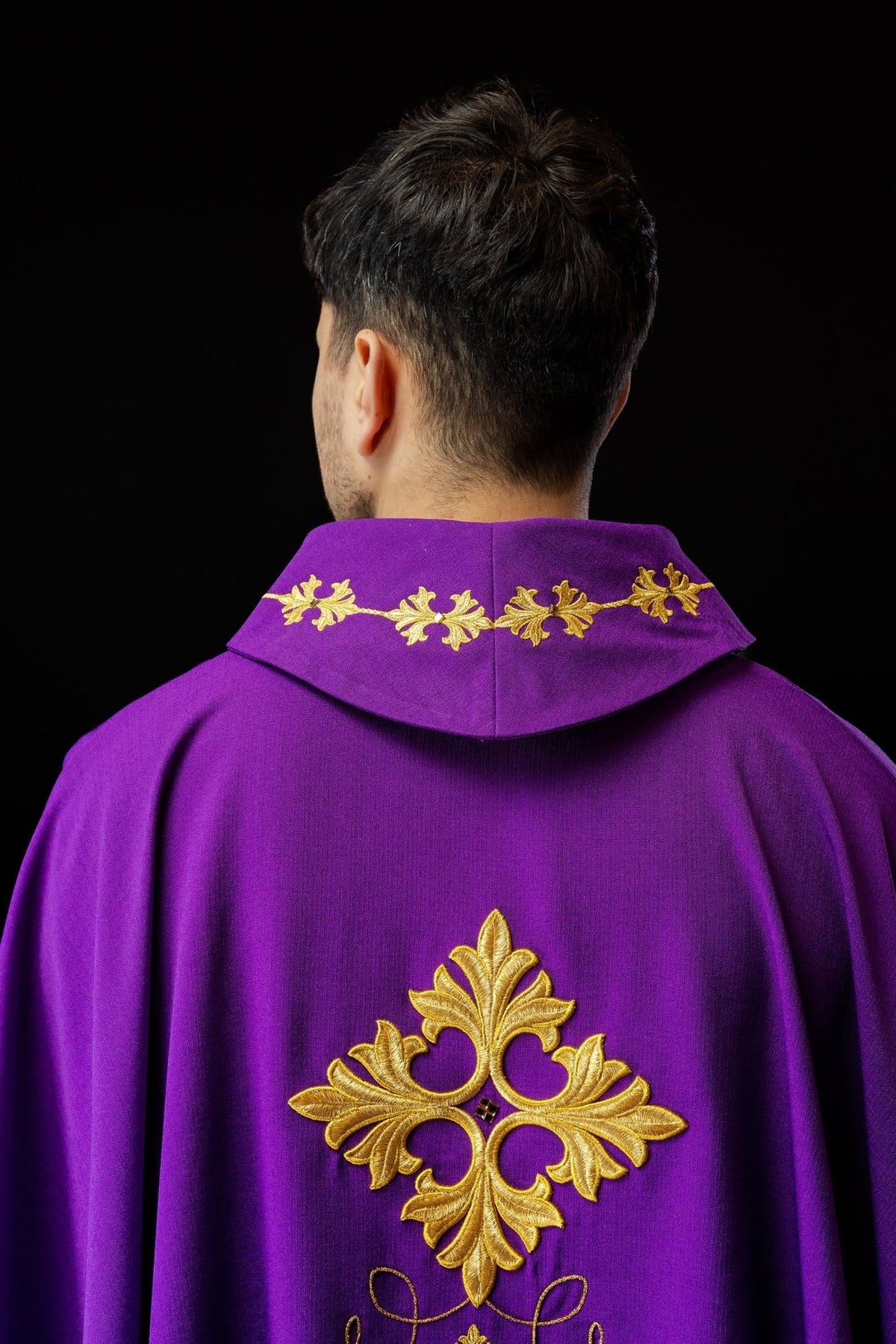 Purple chasuble back close-up with gold embroidered collar and cross