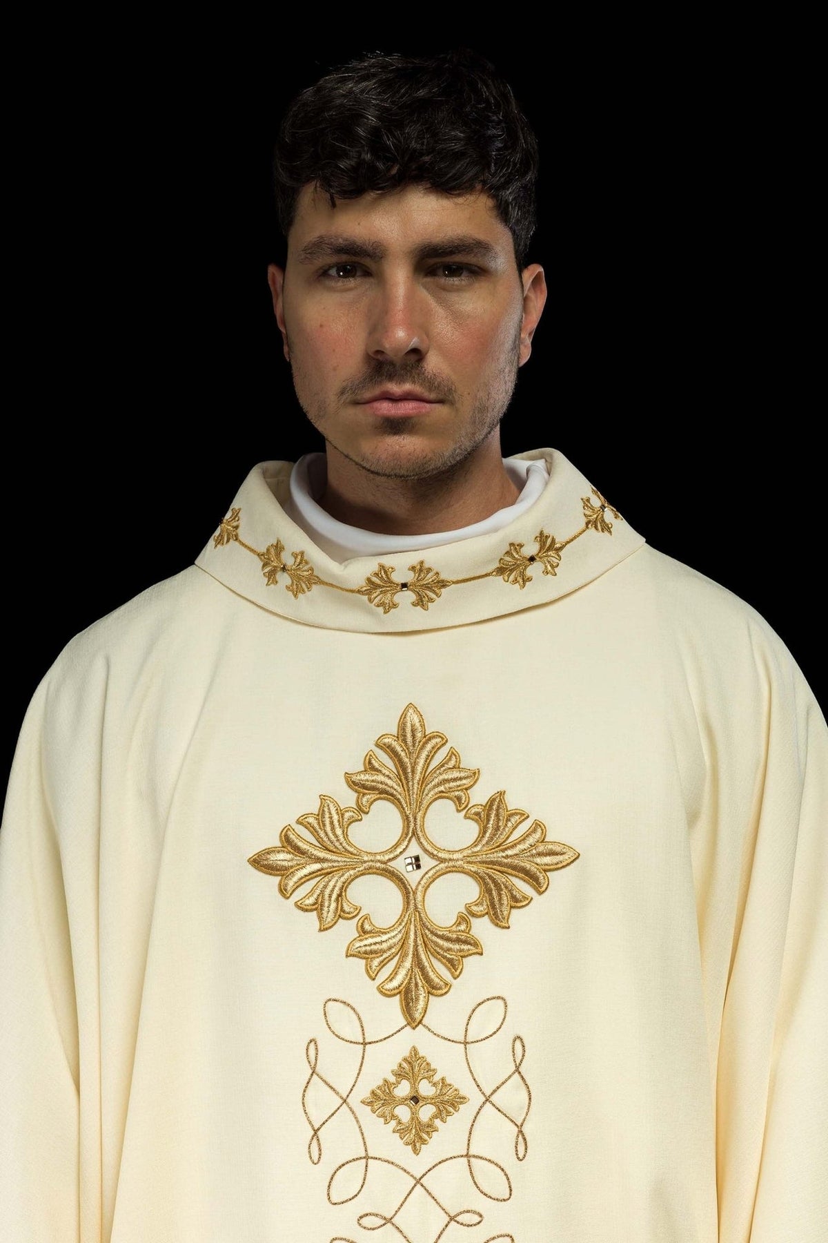 Embroidered chasuble front close-up with gold cross, scrolling motifs and decorated collar