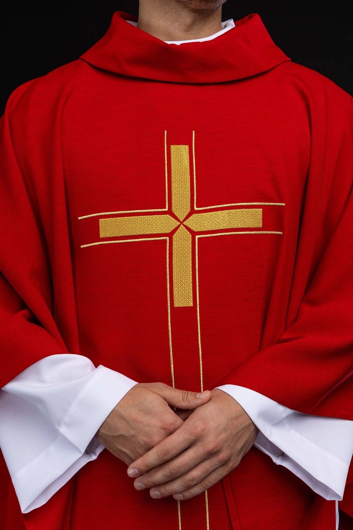 Red chasuble close-up showing stand-up collar and gold cross embroidery