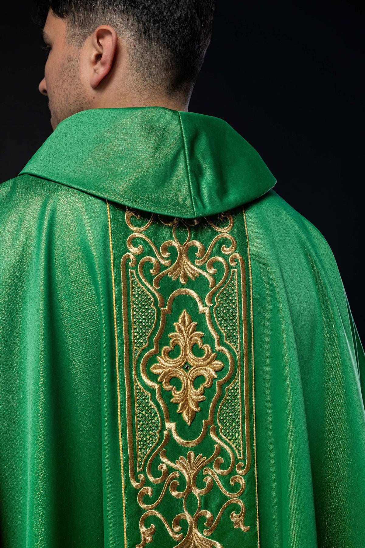 Green chasuble front detail with ornate gold embroidery and lower trim