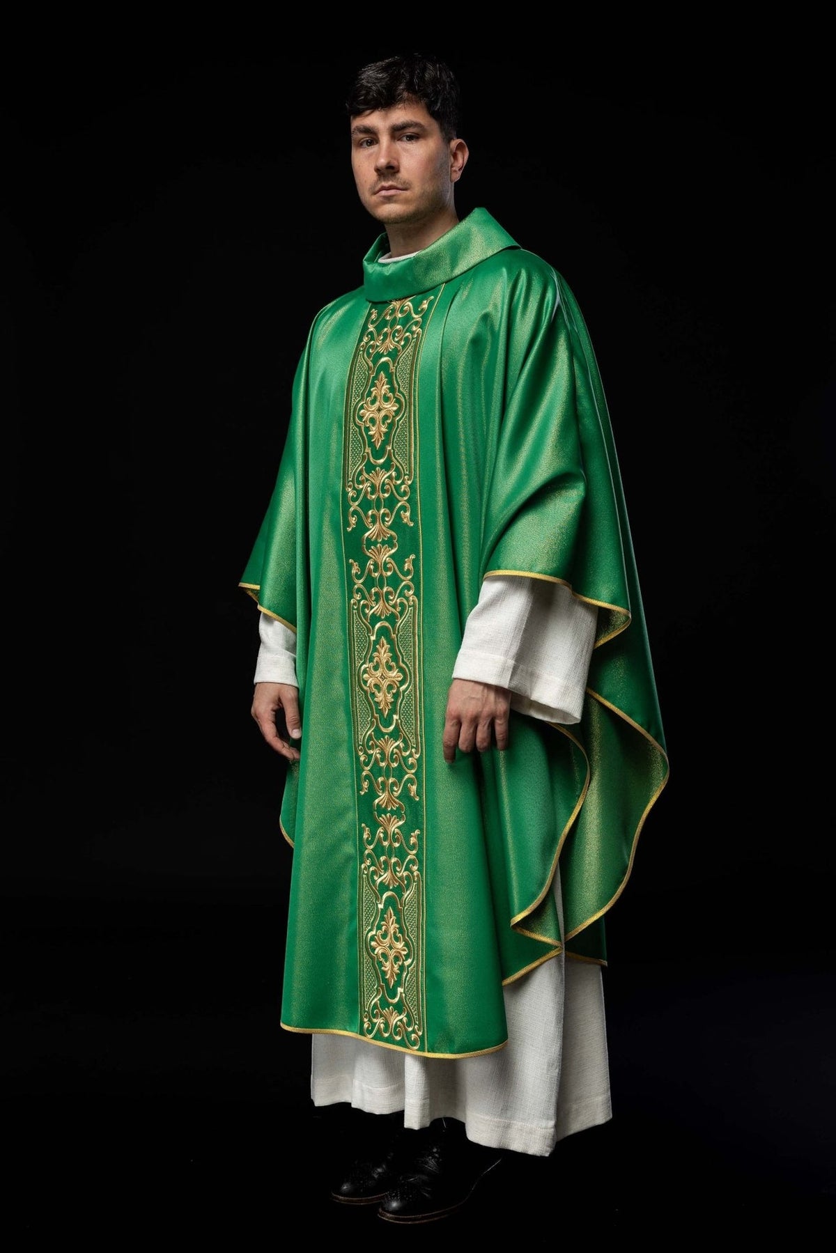 Green embroidered chasuble, angled view showing gold trim and shimmering fabric