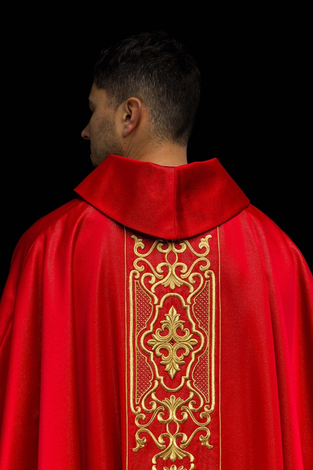 Red chasuble back view with ornate gold embroidery and stand-up collar