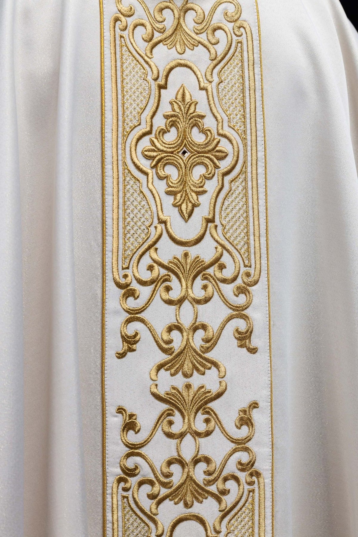 Chasuble orphrey close-up showing ornate gold embroidery and repeating floral motifs