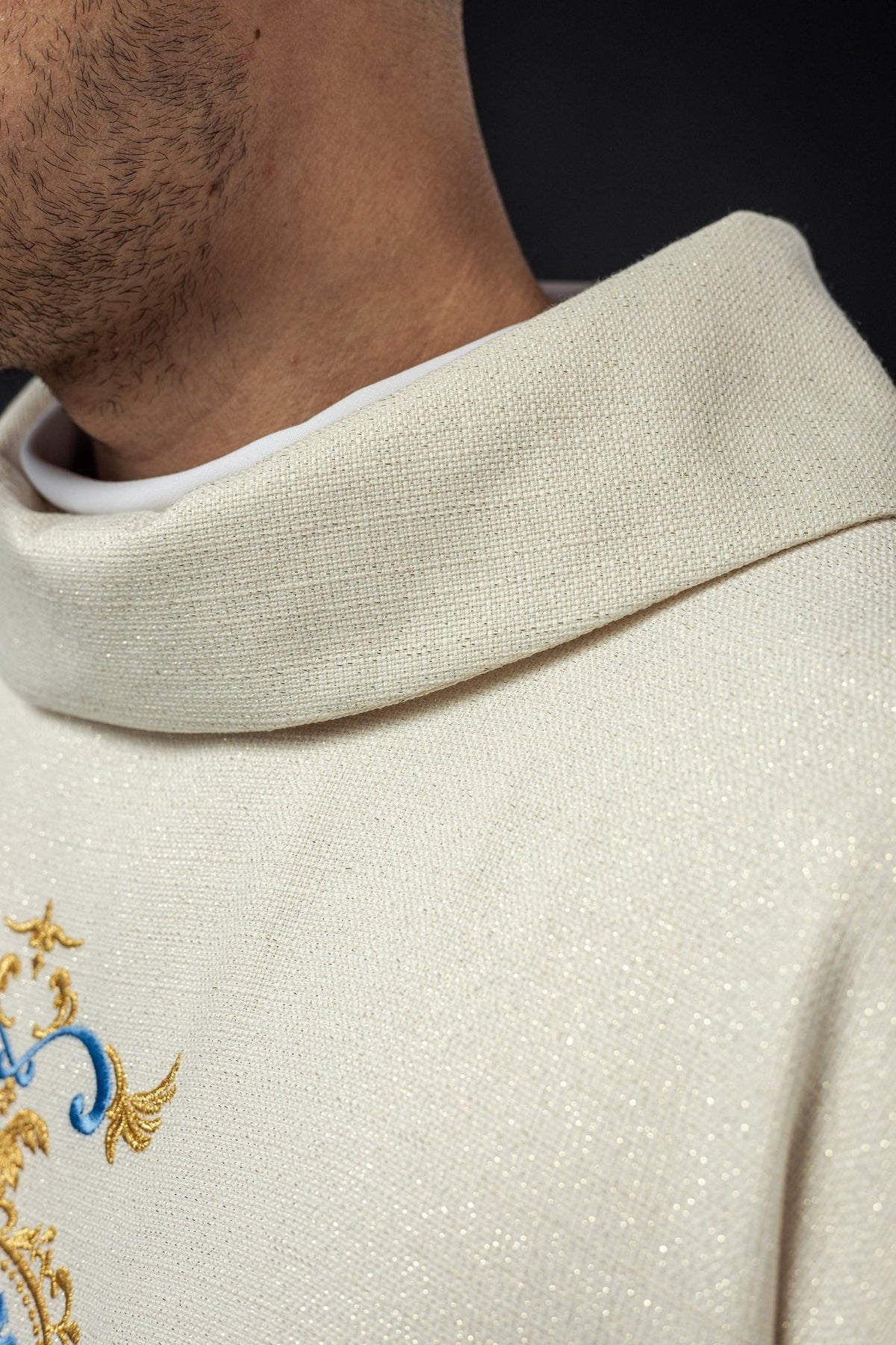 Ivory chasuble close-up showing shimmering fabric and stand-up collar