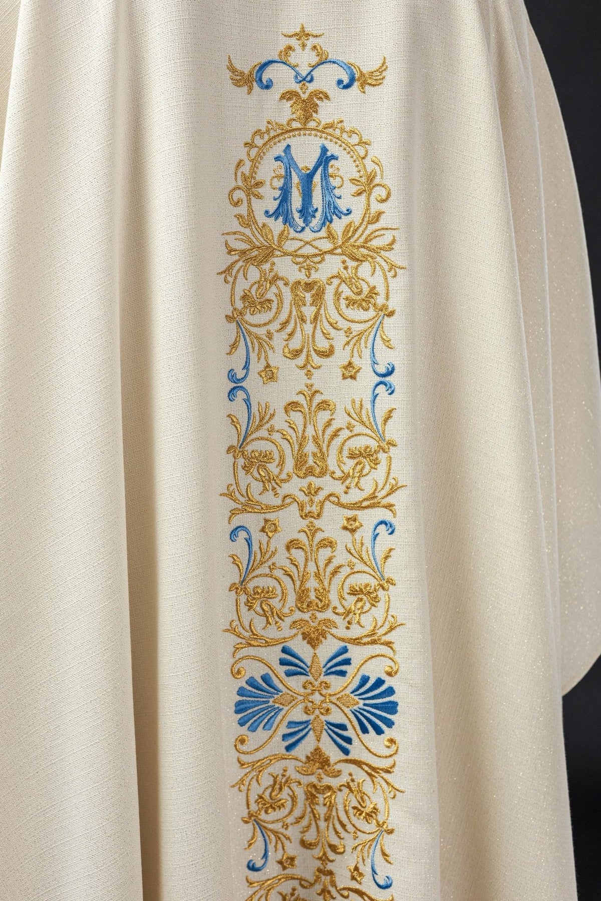 Ivory chasuble back view with full blue and gold embroidered panel