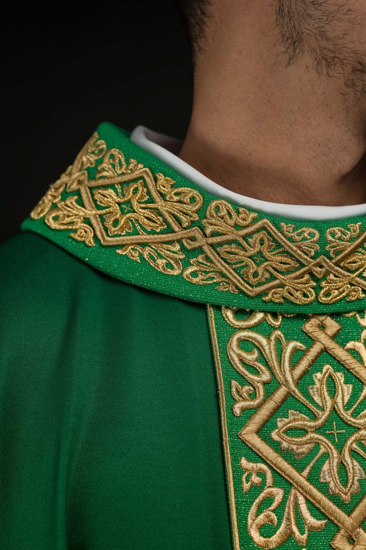Green chasuble side close-up with gold embroidered central trim