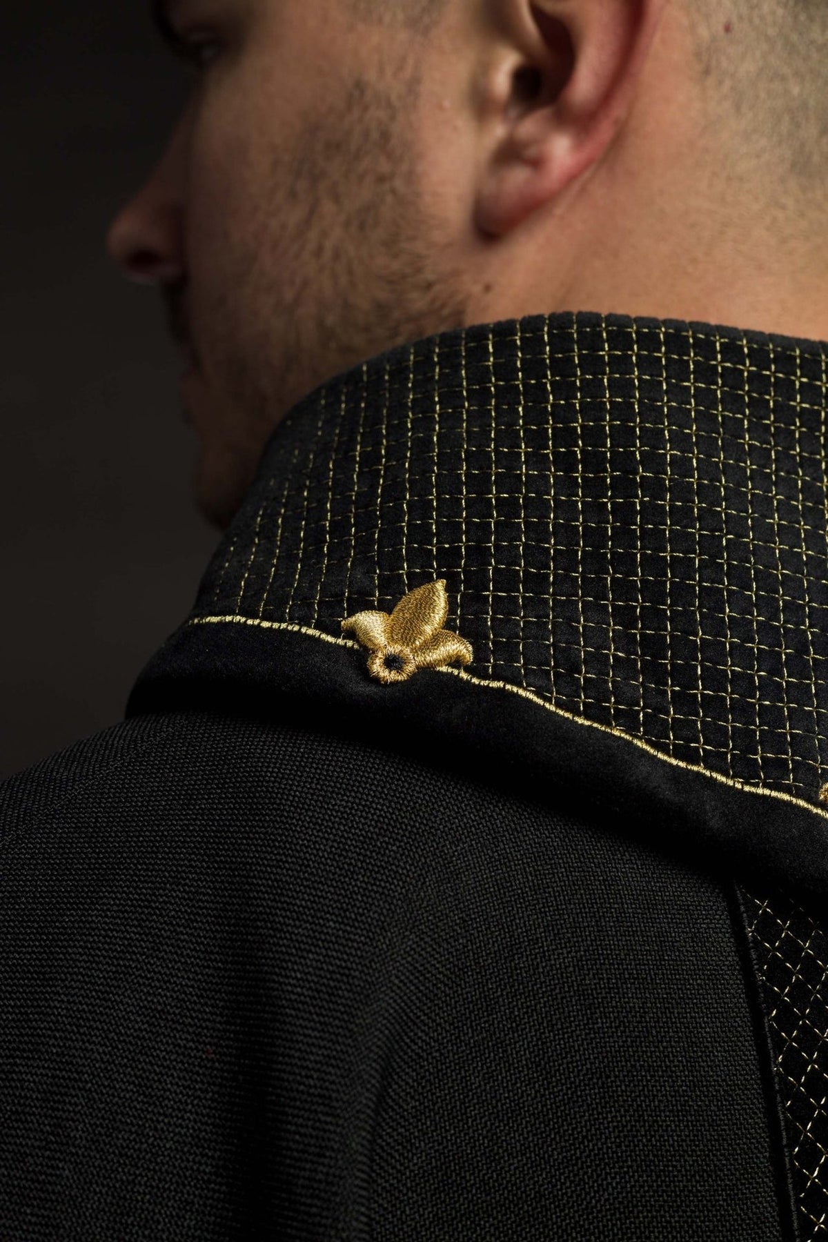 Black velvet chasuble close-up of gold fleur-de-lis embroidery on the stand-up collar