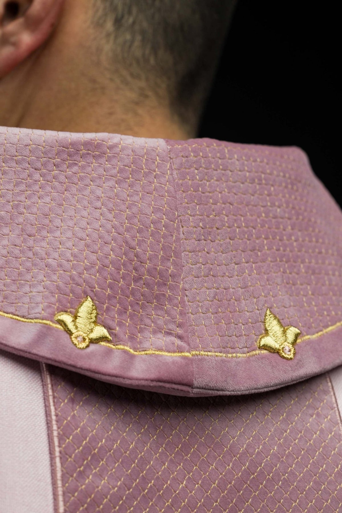 Quilted pink stand-up collar with gold trim and embroidered motifs