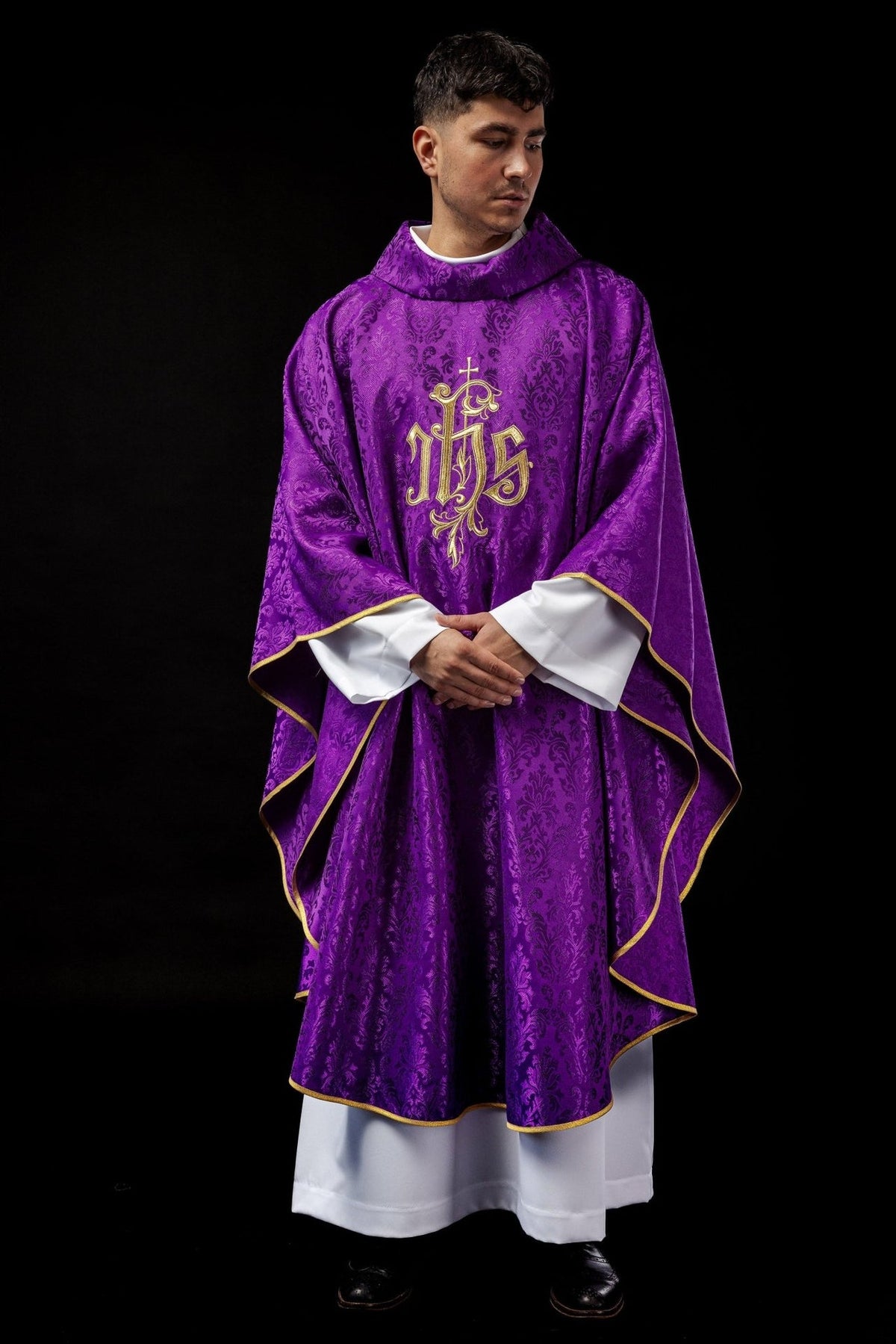 Purple chasuble back close-up with gold embroidered IHS motif