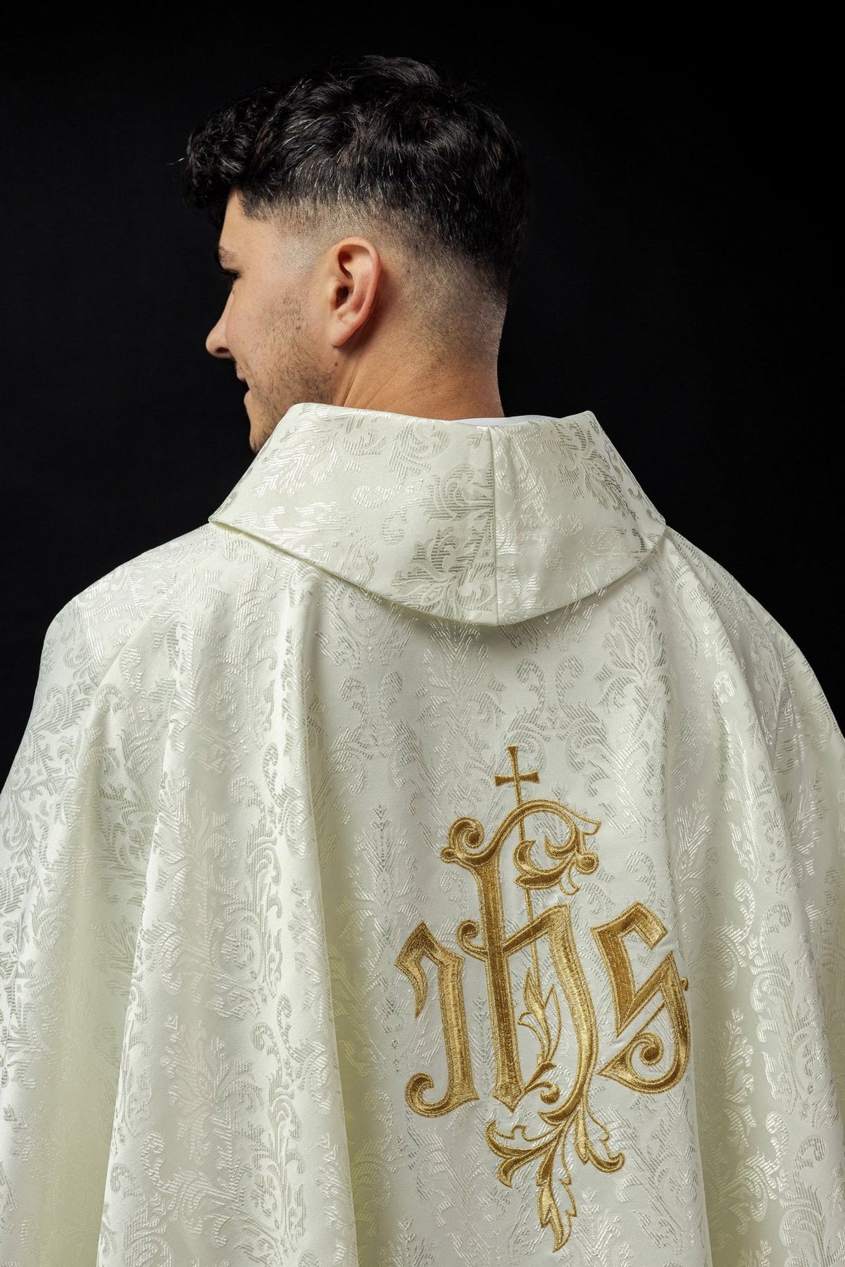 Ecru chasuble back view with gold IHS embroidery and decorative fabric