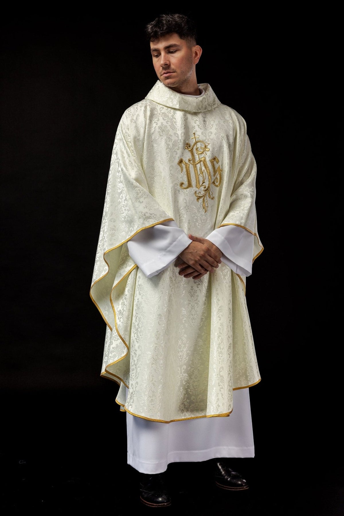 Ecru chasuble front view with decorative fabric, gold trim and IHS embroidery